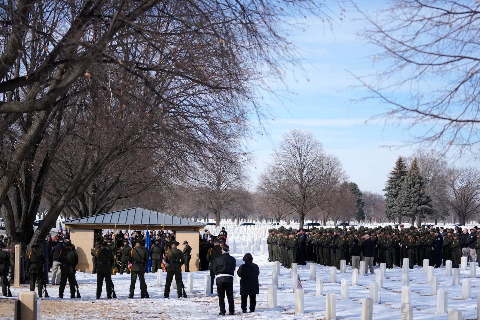 U.S. Border Patrol agent David Maland is recognized with military honors before his burial at Fort Snelling National Cemetery in Minneapolis, on Saturday, Feb. 22, 2025. (AP Photo/Abbie Parr)