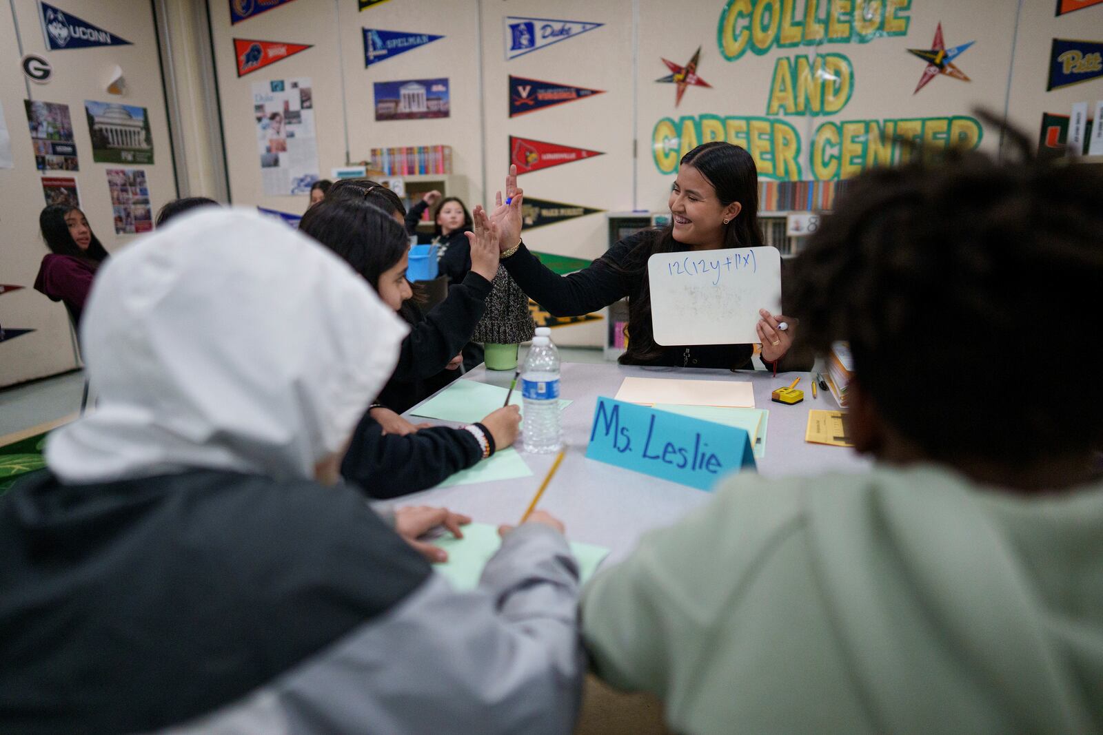 A tutor helps students at Benjamin O. Davis Middle School in Compton, Calif., Thursday, Feb. 6,, 2025. (AP Photo/Eric Thayer)