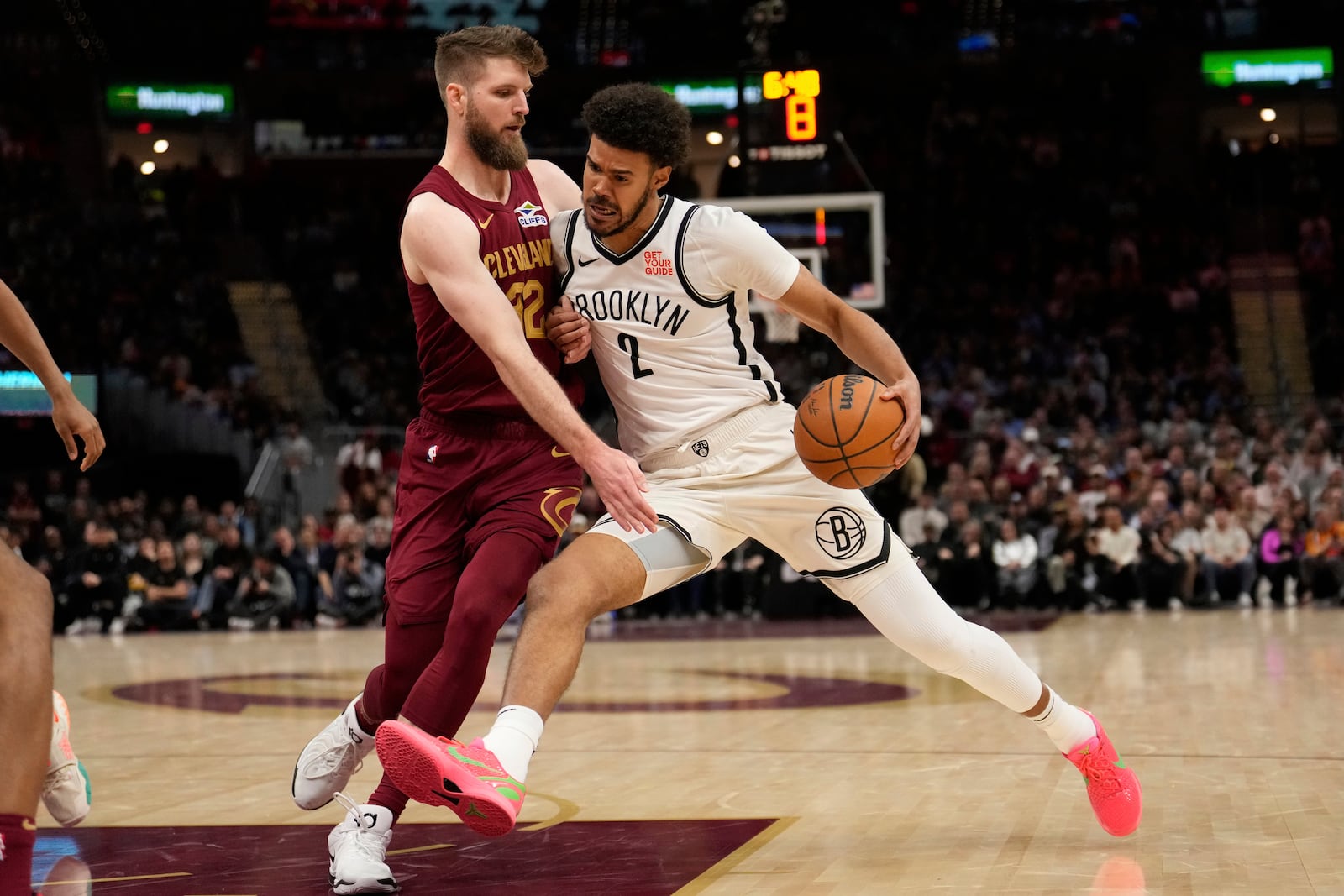 Brooklyn Nets forward Cameron Johnson (2) drives against Cleveland Cavaliers forward Dean Wade (32) in the second half of an NBA basketball game, Tuesday, March 11, 2025, in Cleveland. (AP Photo/Sue Ogrocki)