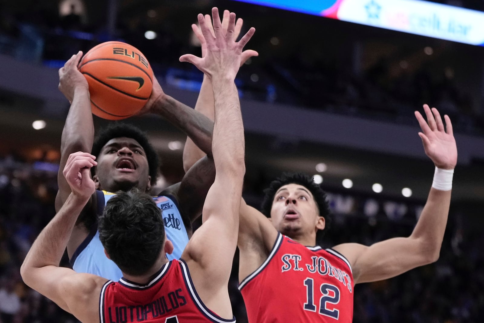 Marquette's Kam Jones shoots past St. John's's Lefteris Liotopoulos and RJ Luis Jr. during the first half of an NCAA college basketball game Saturday, Mar. 8, 2025, in Milwaukee. (AP Photo/Morry Gash)