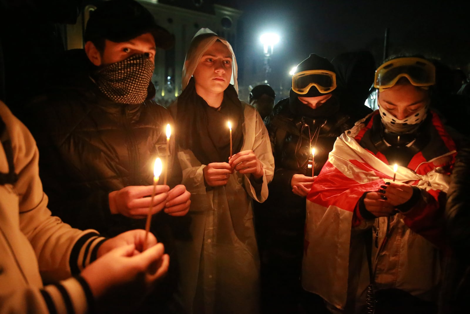 Demonstrators pray during a rally outside the parliament to protest against the government's decision to suspend negotiations on joining the European Union in Tbilisi, Georgia, on Tuesday, Dec. 3, 2024. (AP Photo/Zurab Tsertsvadze)