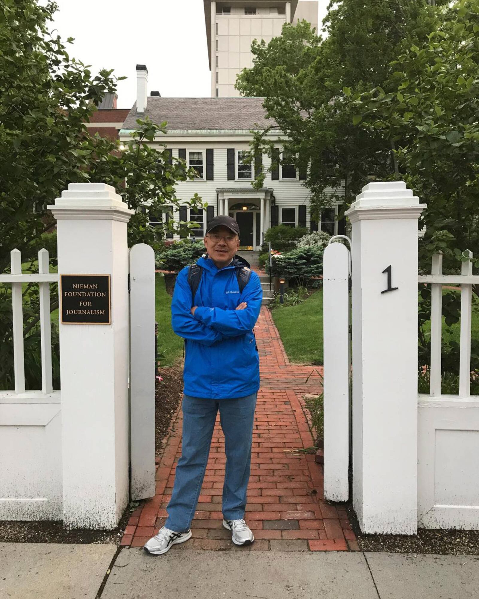 In this photo provided by the Dong family, Chinese journalist Dong Yuyu stands at the gates of the Nieman Foundation for Journalism at Harvard University in Cambridge, Mass., in May 2017. (Dong Family via AP)