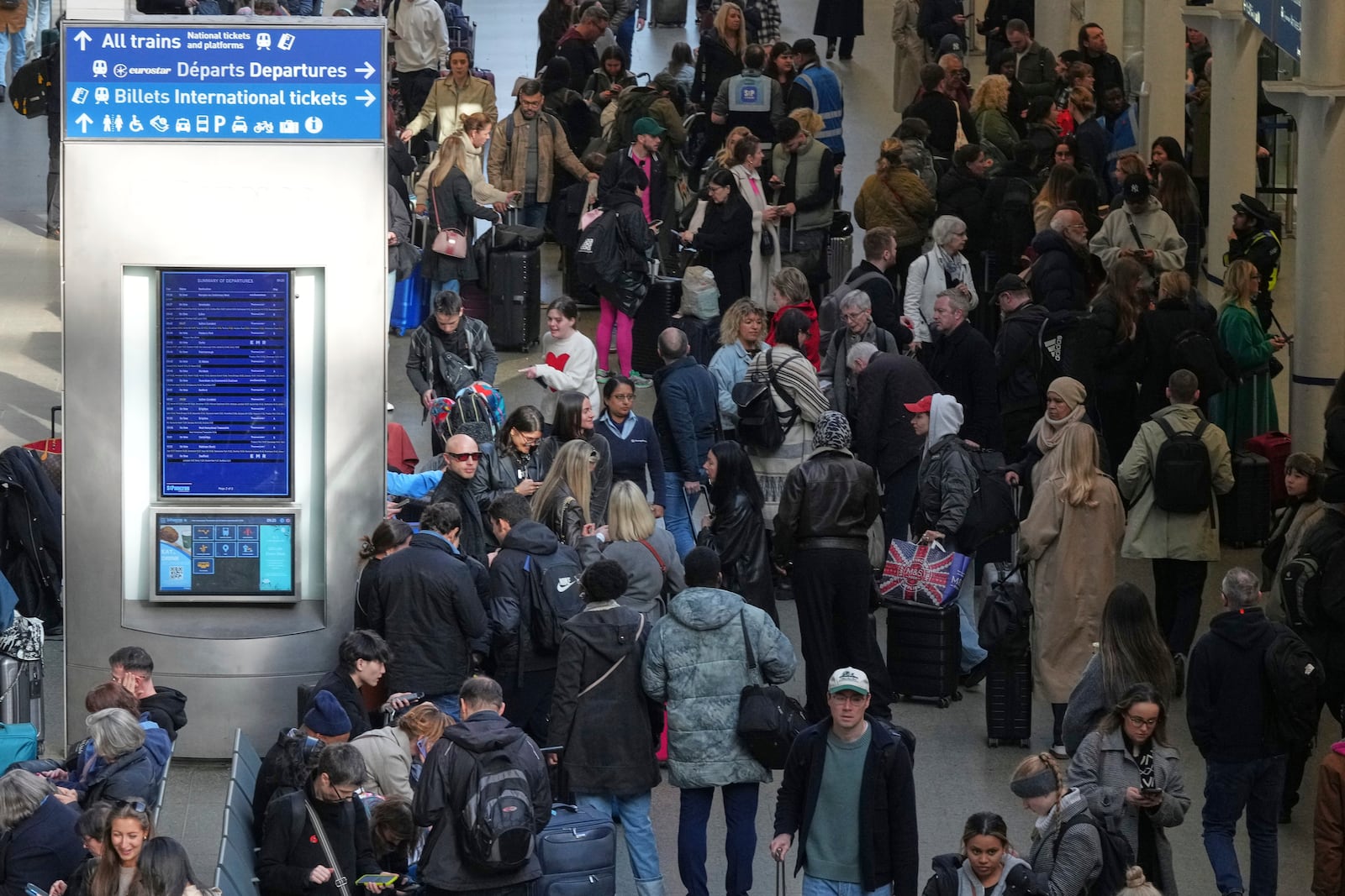 Passengers queue and wait near departures for Eurostar services at St Pancras International station in London, Friday March 7, 2025, after Eurostar trains to the capital have been halted following the discovery of an unexploded Second World War bomb near the tracks in Paris. (AP Photo/Frank Augstein)