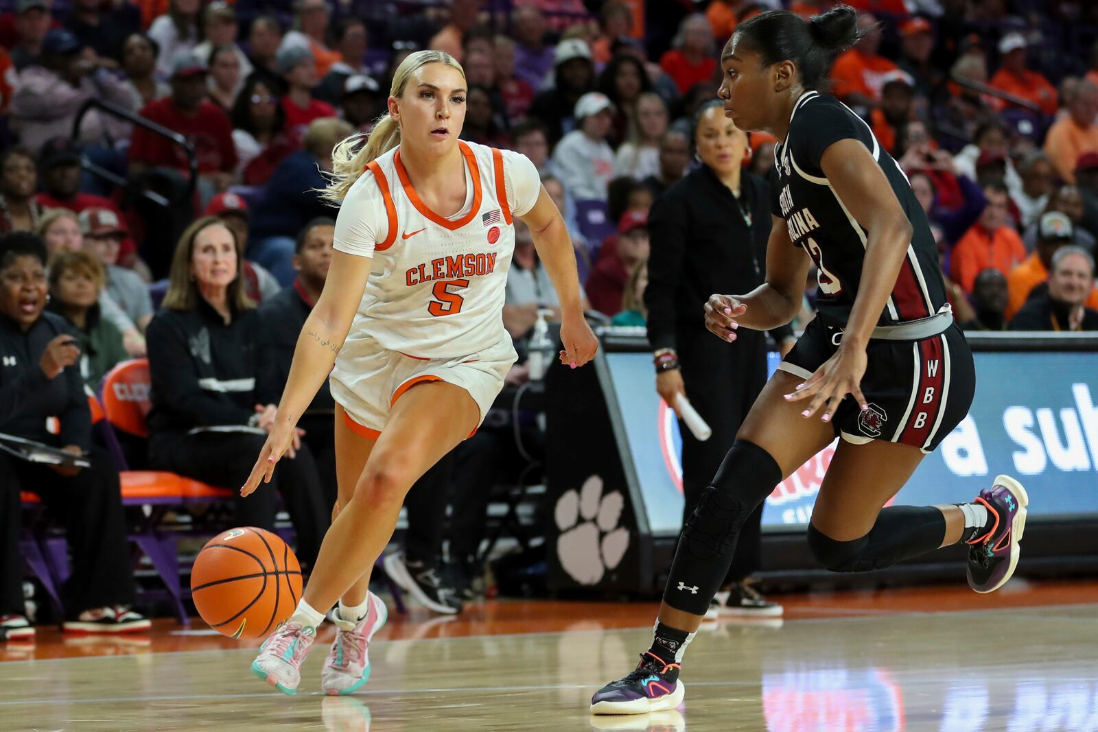 Clemson guard Hannah Kohn (5) drives to the basket past South Carolina guard Bree Hall (23) during the first half of an NCAA college basketball game Wednesday, Nov. 20, 2024, in Clemson, S.C. (AP Photo/Artie Walker Jr.)