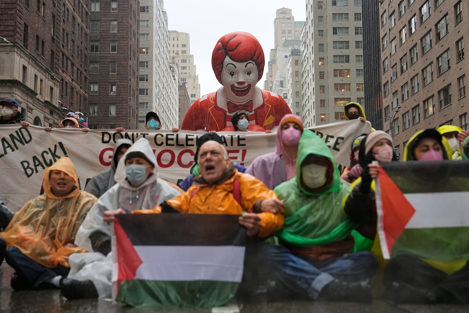 Pro-Palestinian protesters demonstrate on Sixth Avenue during the Macy's Thanksgiving Day Parade, Thursday, Nov. 28, 2024, in New York. (AP Photo/Julia Demaree Nikhinson)