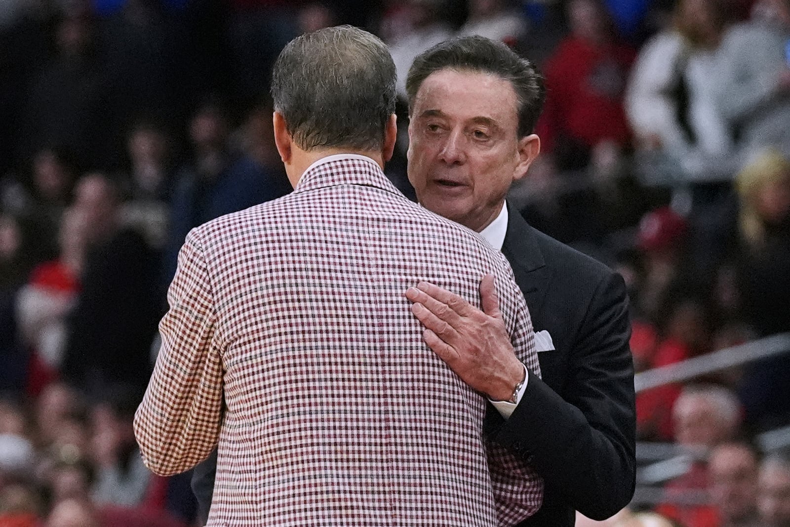 St. John's head coach Rick Pitino, right, gives Arkansas head coach John Calipari a pat on the back after a loss in the second round of the NCAA college basketball tournament, Saturday, March 22, 2025, in Providence, R.I. (AP Photo/Charles Krupa)