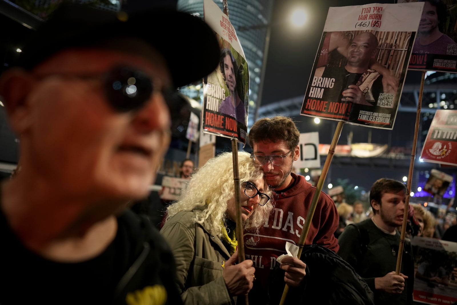 Relatives and friends of people killed and abducted by Hamas and taken into Gaza, react to the ceasefire announcement as they take part in a demonstration in Tel Aviv, Israel, Wednesday, Jan. 15, 2025. (AP Photo/Oded Balilty)