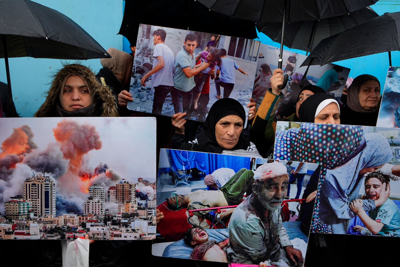 FILE - Palestinian Hamas supporters hold posters shows the Israeli bombardment on Gaza during a protest demanding that staff who were fired in the Gaza Strip over allegations that they took part in the Oct. 7, attack on southern Israel be returned to their jobs and that countries resume funding of the agency, in front of the United Nations Relief and Works Agency (UNRWA) headquarters in Beirut, Tuesday, Jan. 30, 2024. (AP Photo/Bilal Hussein, File)