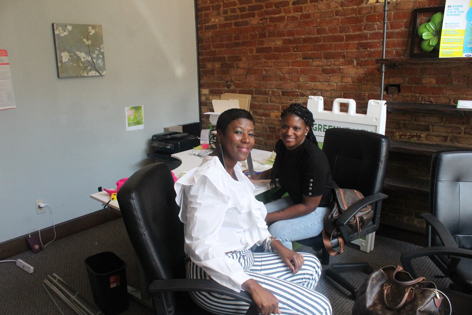 The Oregon District continues to recover from Sunday's morning mass shooting.  Pictured: Shondale Atkinson (black top) of Serendipity Community Care and  Denise Henton of Single Parents Rock.