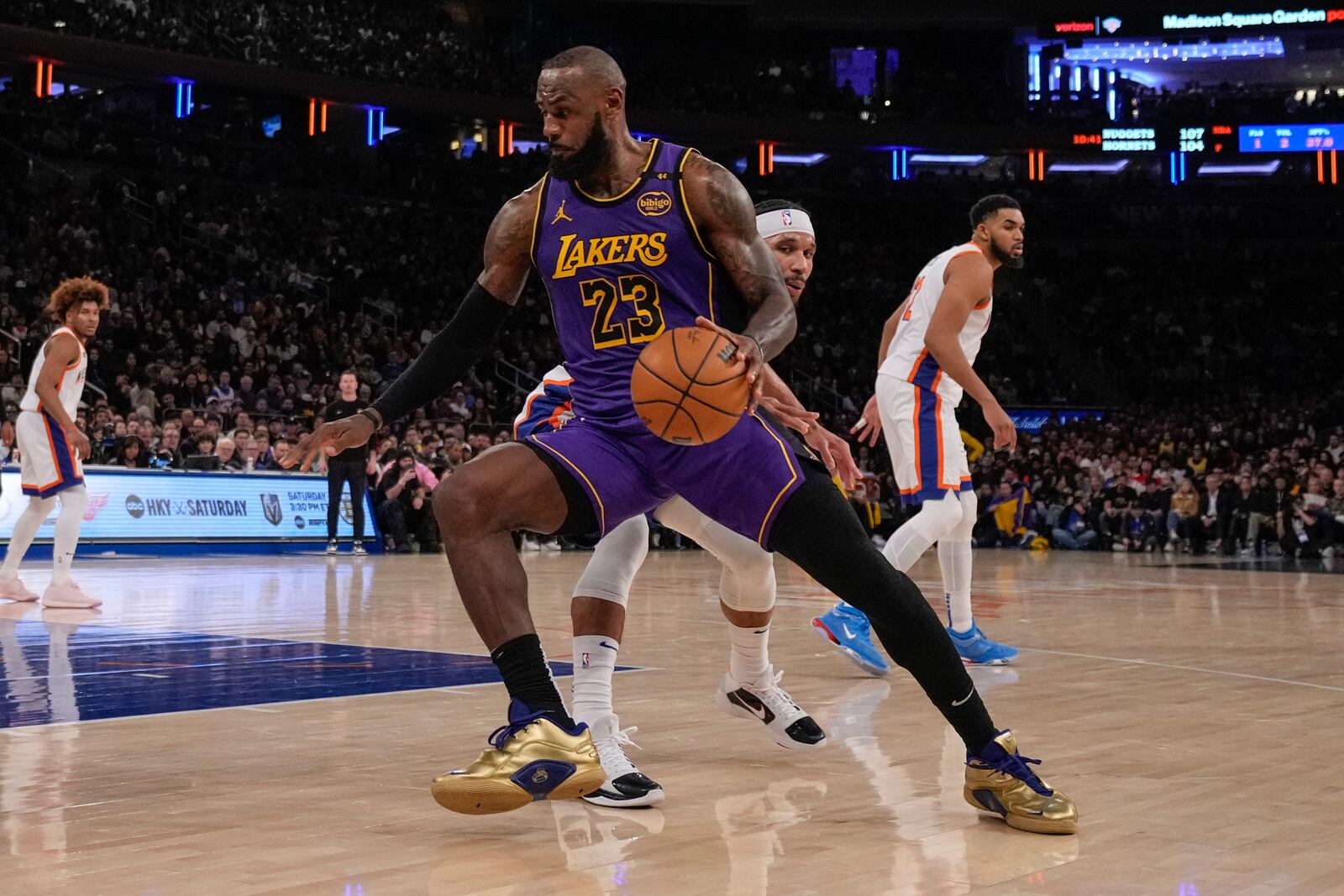 Los Angeles Lakers' LeBron James (23) spins away from New York Knicks' Josh Hart (3) during the second half of an NBA basketball game Saturday, Feb. 1, 2025, in New York. (AP Photo/Frank Franklin II)