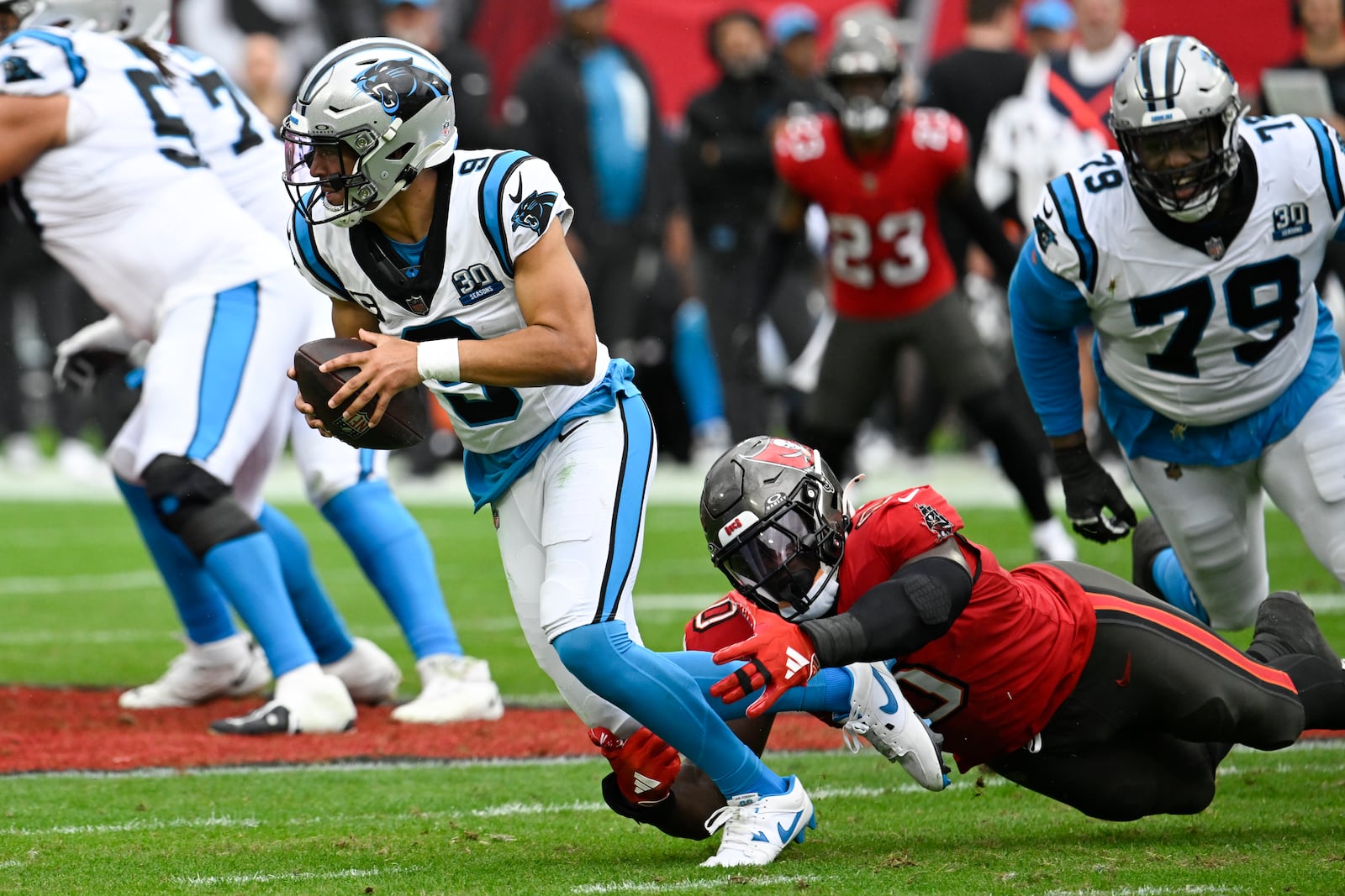 Carolina Panthers tight end Ja'Tavion Sanders is sacked by Tampa Bay Buccaneers linebacker Yaya Diaby during the second half of an NFL football game Sunday, Dec. 29, 2024, in Tampa, Fla. (AP Photo/Jason Behnken)