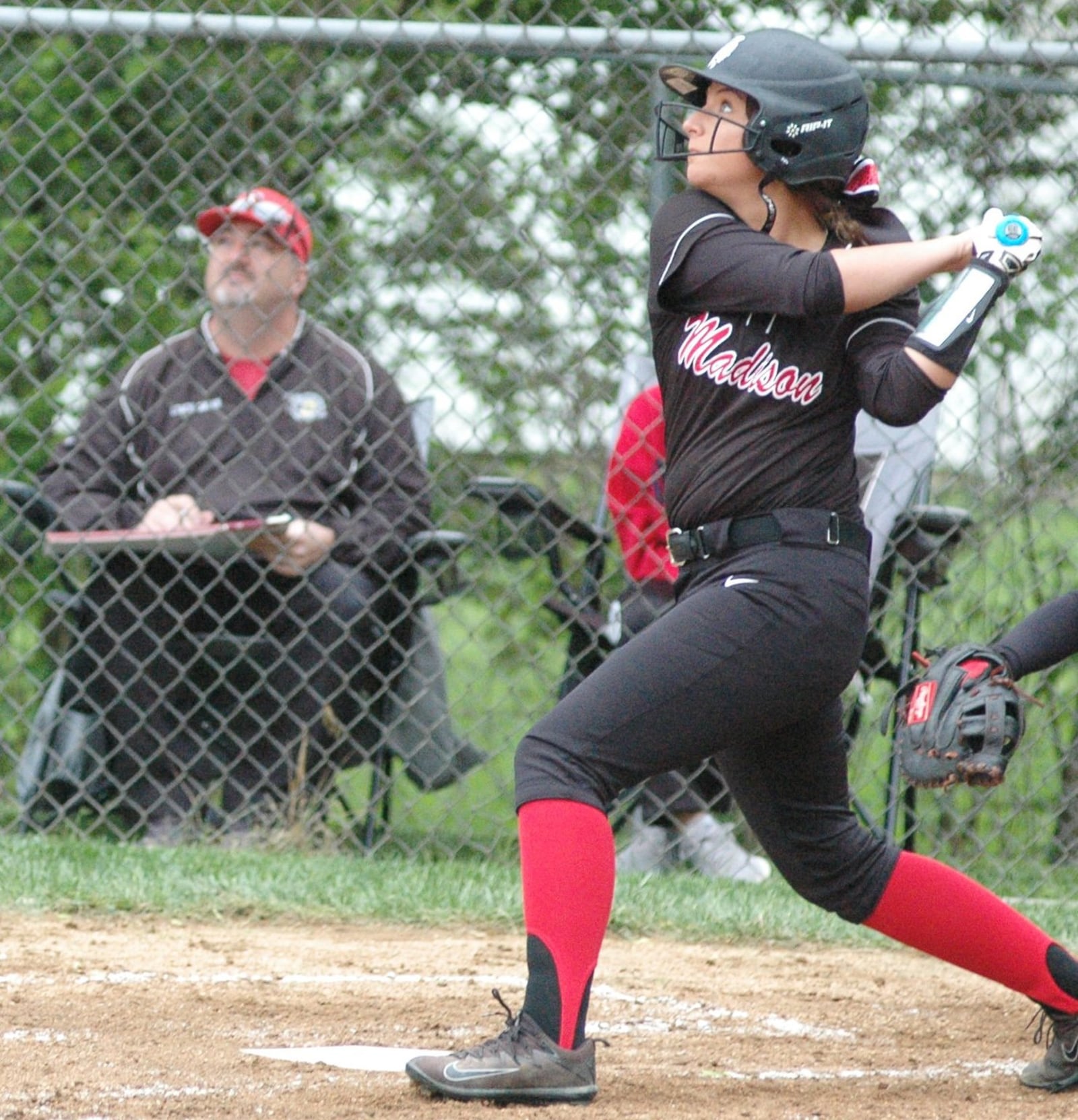 Madison’s Mackenzie New-Magnus keeps her eye on the ball Monday during a Division III district softball semifinal against Deer Park at Wyoming. Deer Park won 6-3. RICK CASSANO/STAFF