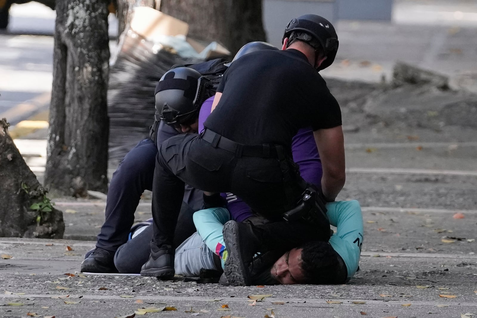 Police detain an opponent of Venezuelan President Nicolas Maduro during a protest the day before his inauguration for a third term in Caracas, Venezuela, Thursday, Jan. 9, 2025. (AP Photo/Matias Delacroix)