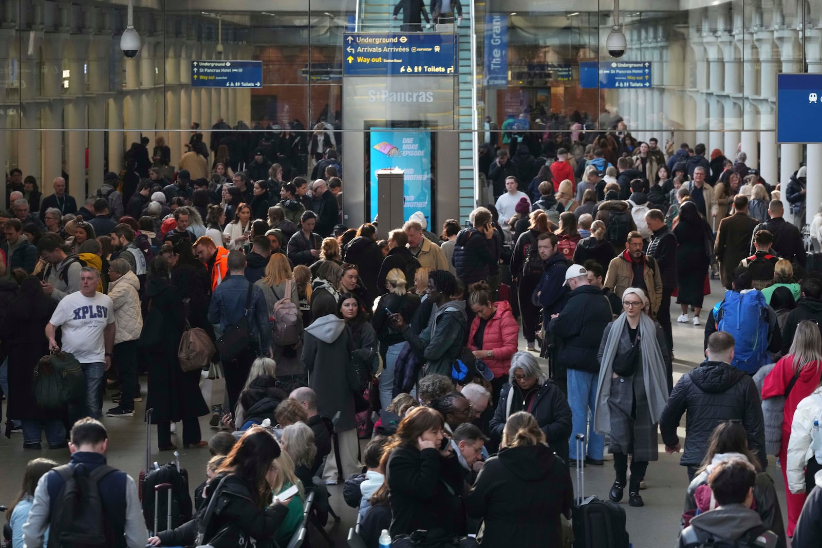 Passengers queue and wait near departures for Eurostar services at St Pancras International station in London, Friday March 7, 2025, after Eurostar trains to the capital have been halted following the discovery of an unexploded Second World War bomb near the tracks in Paris. (AP Photo/Frank Augstein)