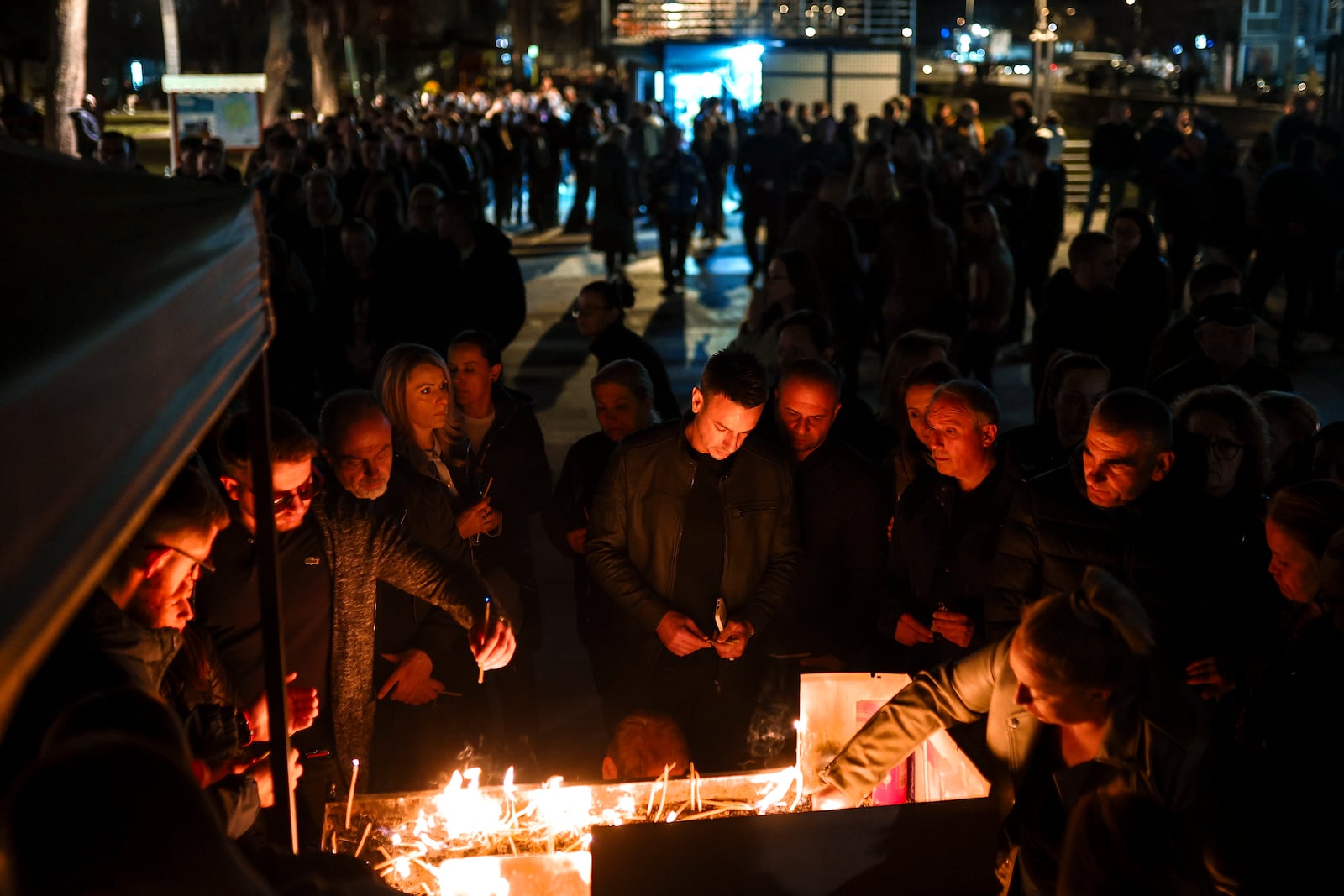 People wait in lines to light candles in the town of Kocani, North Macedonia, Sunday, March 16, 2025, following a massive fire in the nightclub early Sunday. (AP Photo/Armin Durgut)