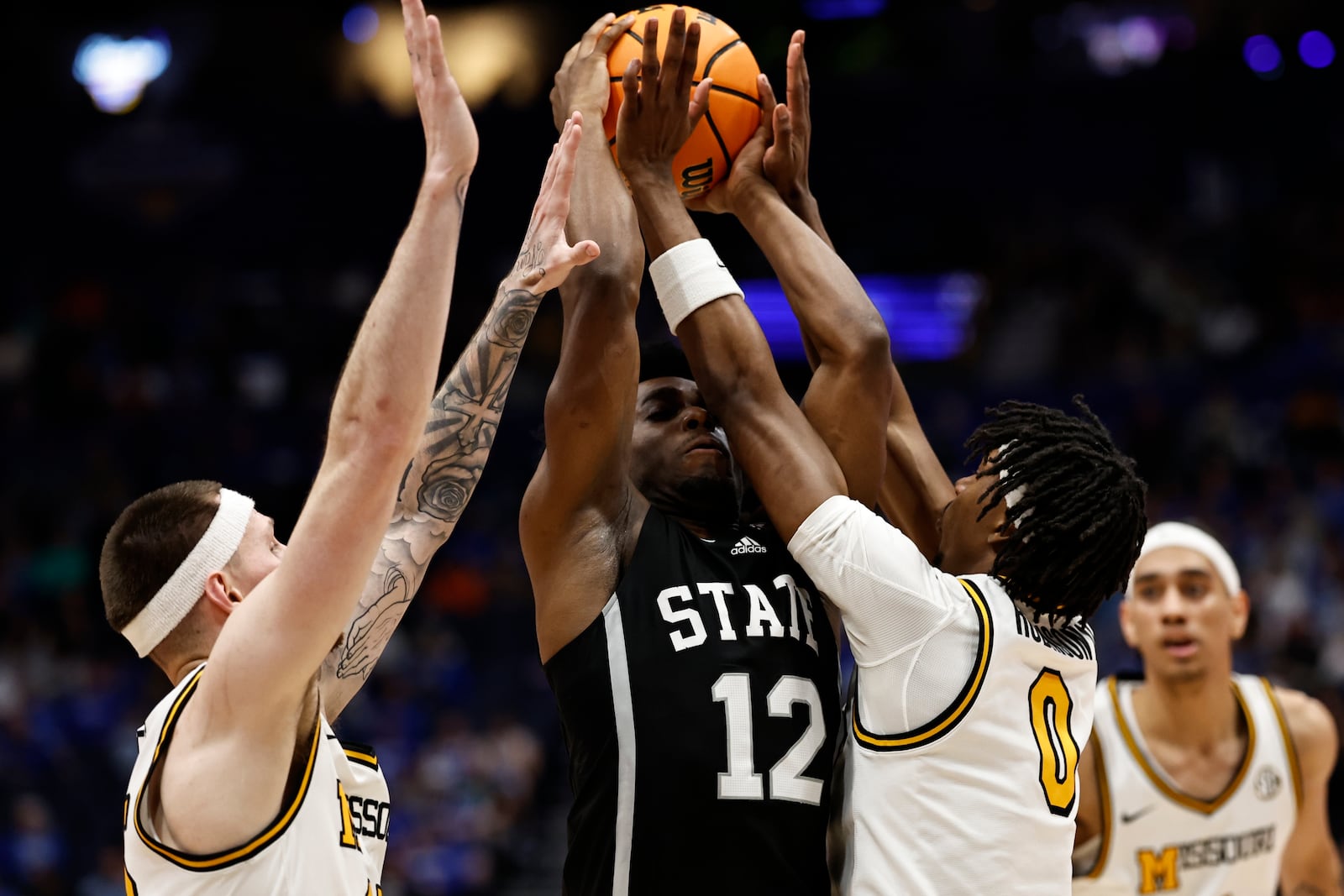 Mississippi State guard Josh Hubbard (12) is defended by Missouri guard Anthony Robinson II (0) during the second half of an NCAA college basketball game in the second round of the Southeastern Conference tournament, Thursday, March 13, 2025, in Nashville, Tenn. (AP Photo/Wade Payne)