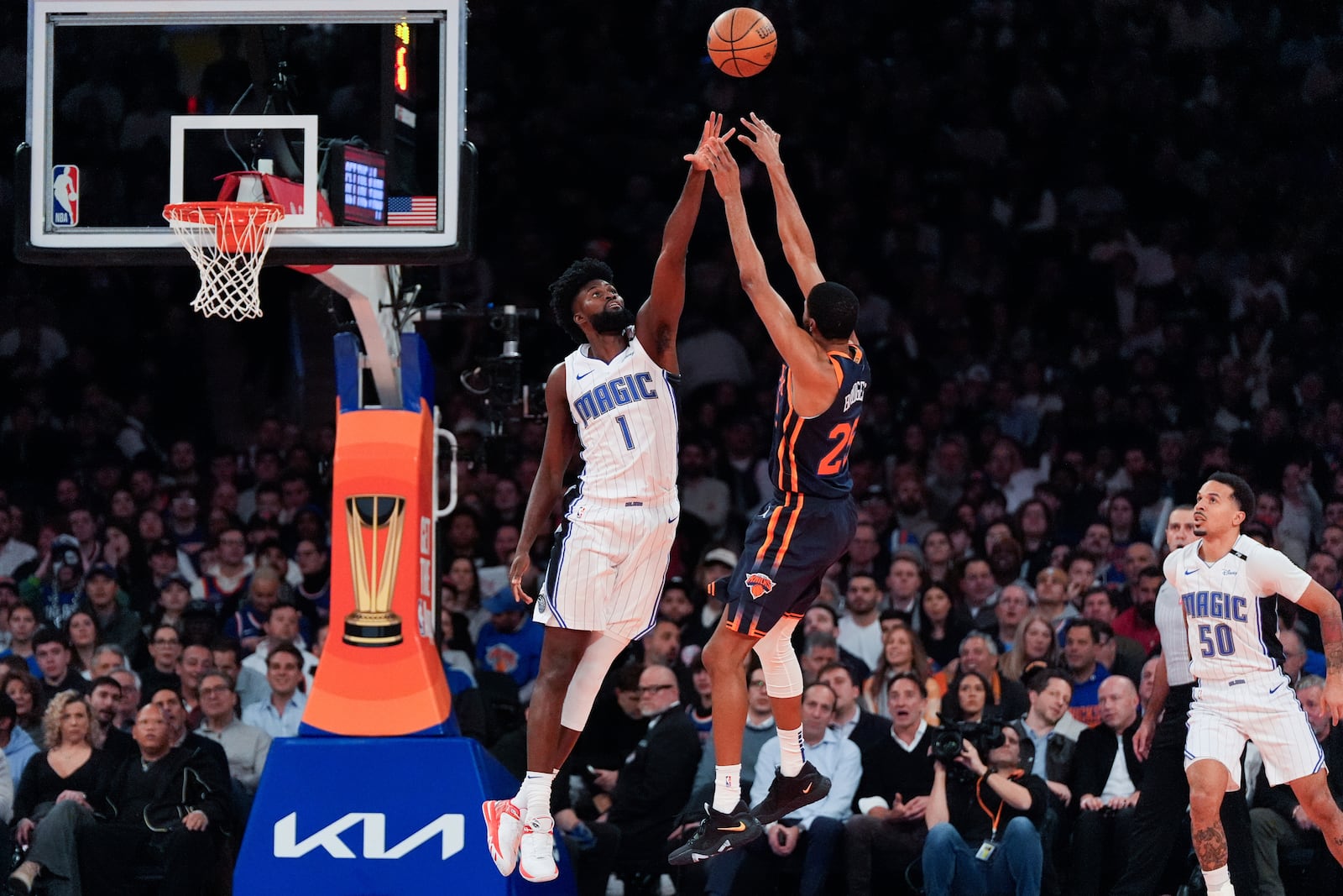 New York Knicks forward Mikal Bridges (25) shoots past Orlando Magic forward Jonathan Isaac (1) during the first half of an NBA Cup basketball game, Tuesday, Dec. 3, 2024, in New York, N.Y. (AP Photo/Julia Demaree Nikhinson)