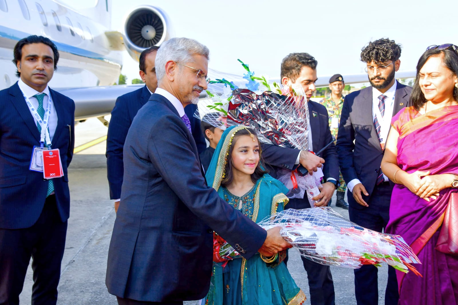 In this photo released by the Press Information Department, India's Minister for External Affairs Subrahmanyam Jaishankar receives a flower bouquet from a girl upon his arrival at an airbase in Rawalpindi, Pakistan, Tuesday, Oct. 15, 2024, ahead of an Asian security group meeting. (Press Information Department via AP)