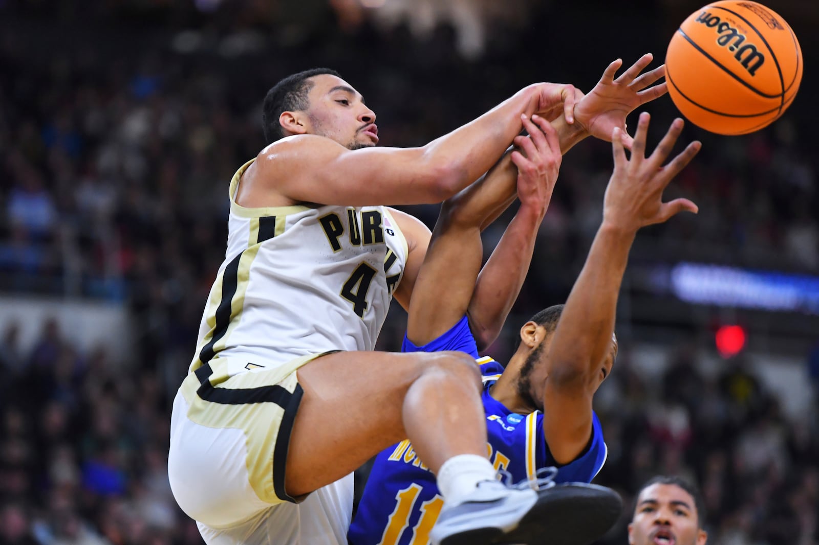 Purdue forward Trey Kaufman-Renn (4) battles for a rebound against McNeese State guard Quadir Copeland (11) during the first half in the second round of the NCAA college basketball tournament, Saturday, March 22, 2025, in Providence, R.I. (AP Photo/Steven Senne)