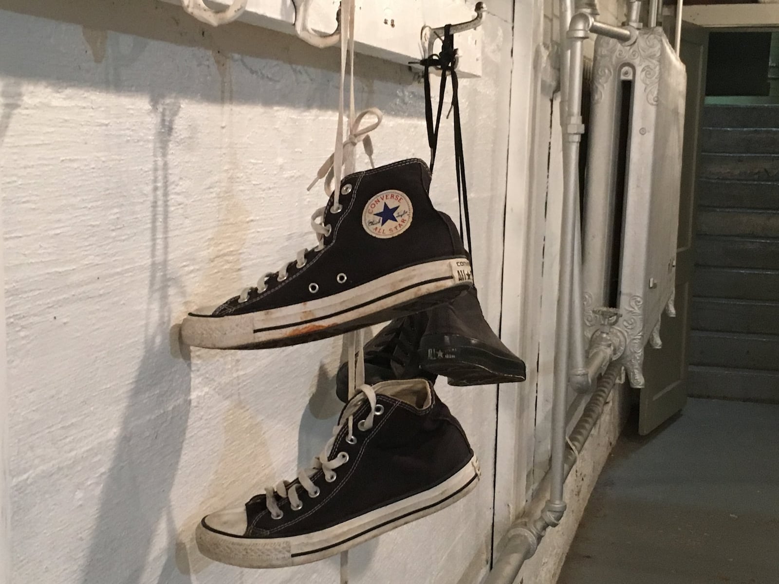 A pair of sneakers hang in one of the locker rooms Saturday afternoon at the Hoosier Gym in Knightstown, Ind., where Talawanda defeated Franklin County (Ind.) 43-40. RICK CASSANO/STAFF