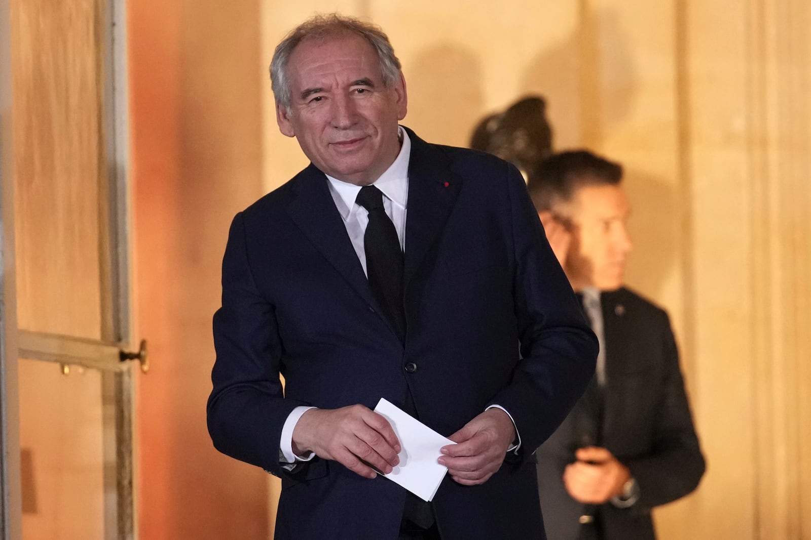 Newly named Prime Minister François Bayrou stands after the handover at the Prime Minister residence, Friday, Dec. 13, 2024 in Paris. (AP Photo/Christophe Ena)