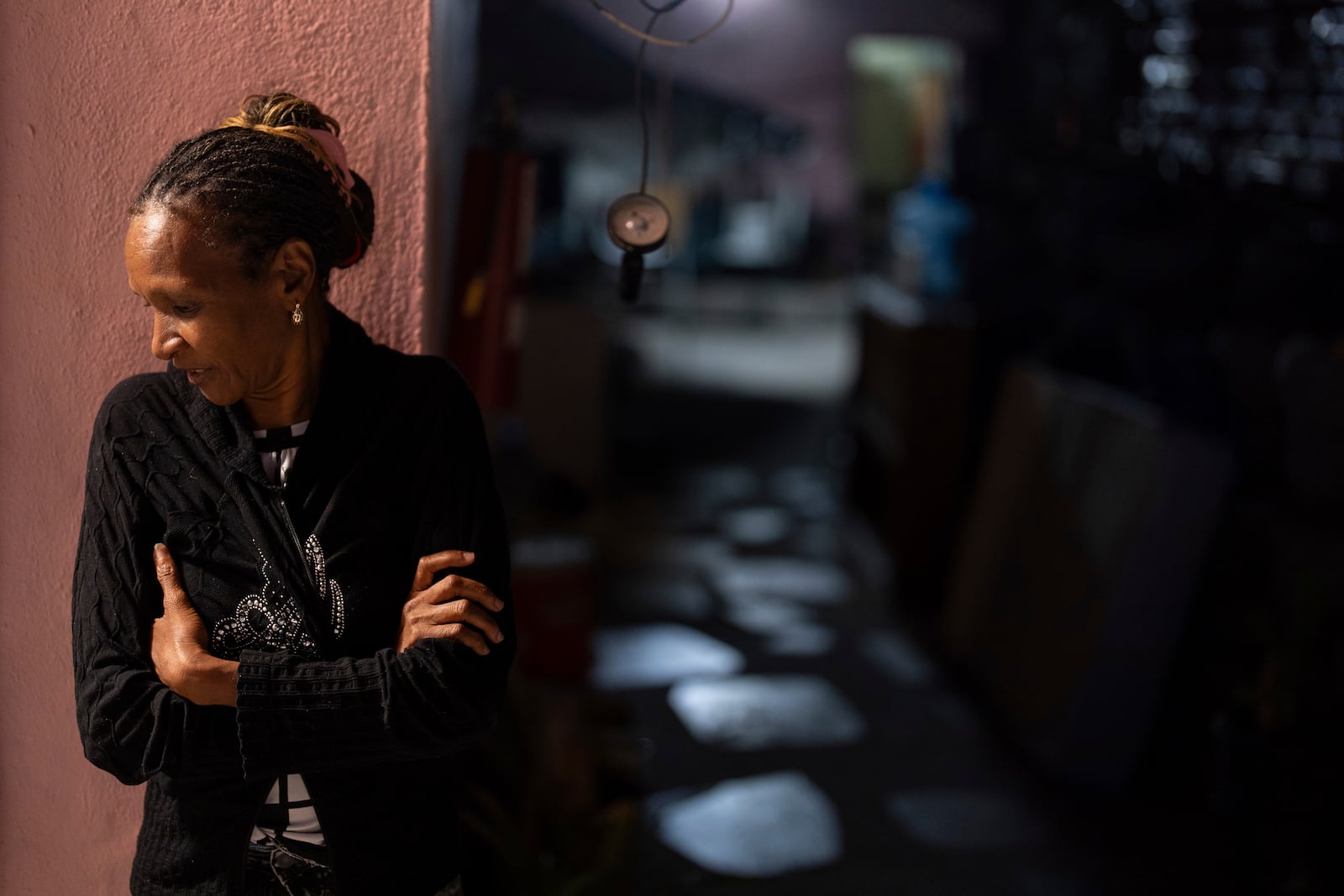 Cuban migrant Naives Tamayo looks on from the doorway of Martha Rosales' house, where she is staying while waiting for an appointment to apply for asylum in the United States through the CBP One app Wednesday, Aug. 28, 2024, in Tijuana, Mexico. (AP Photo/Gregory Bull)