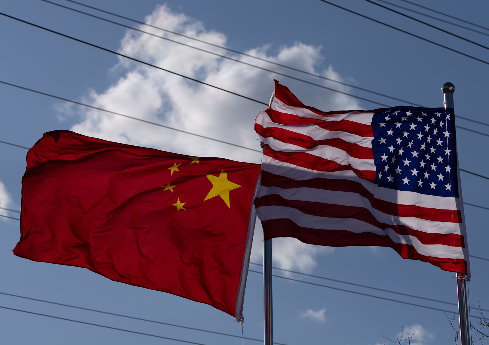 The Chinese and United States flags are flown outside the China International Supply Chain Expo in Beijing, Nov. 27, 2024. (AP Photo/Ng Han Guan)