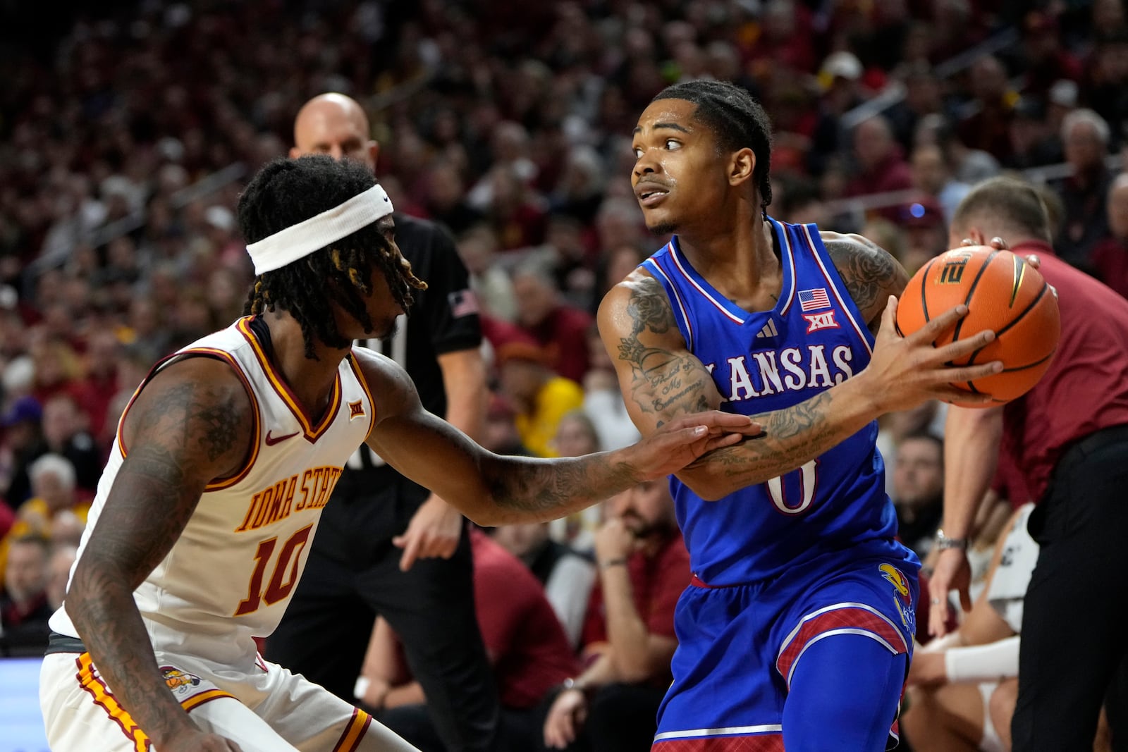 Kansas guard Shakeel Moore looks to pass over Iowa State guard Keshon Gilbert (10) during the first half of an NCAA college basketball game Wednesday, Jan. 15, 2025, in Ames, Iowa. (AP Photo/Charlie Neibergall)