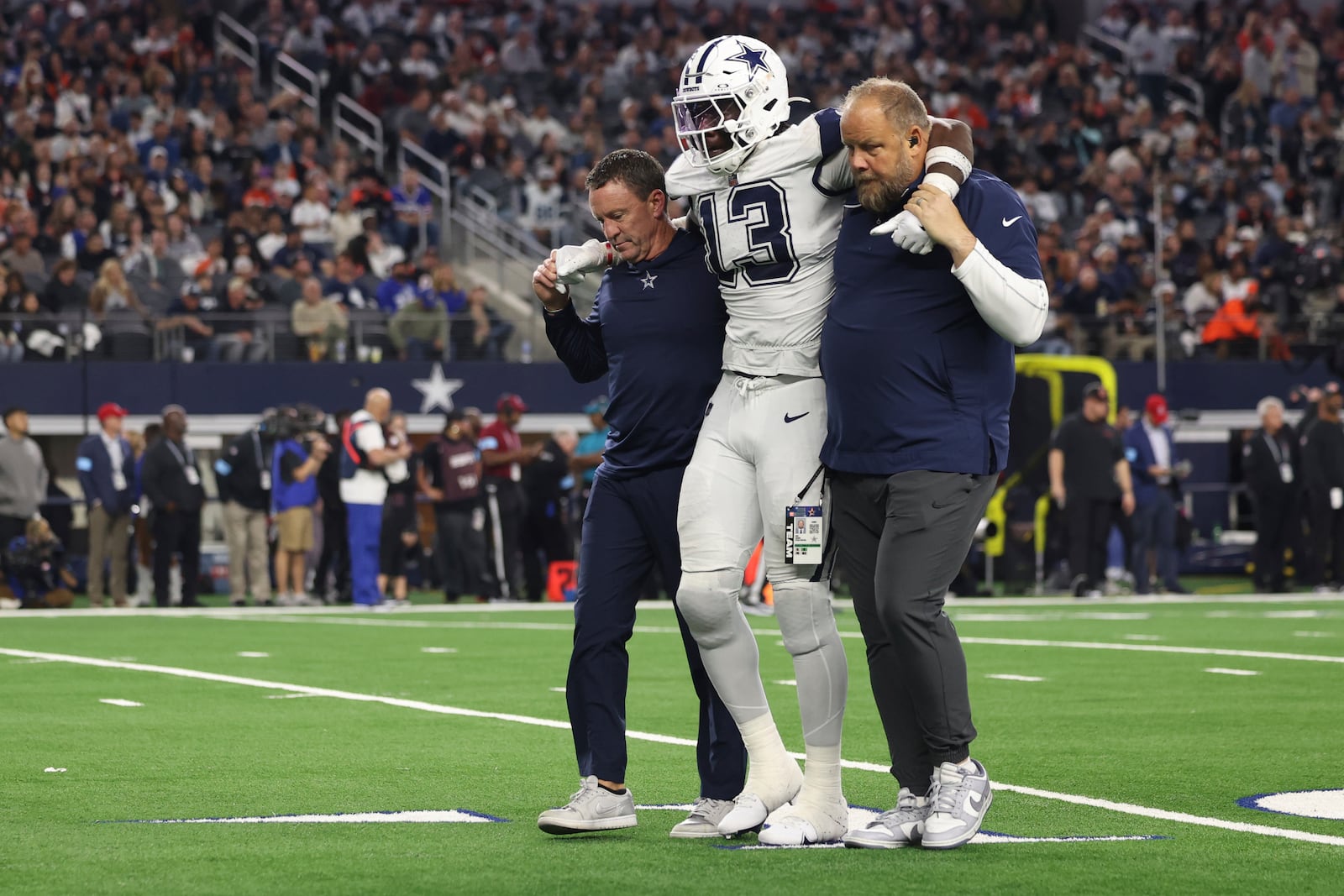 Dallas Cowboys linebacker DeMarvion Overshown is helped off the field after being injured during the second half of an NFL football game against the Cincinnati Bengals, Monday, Dec. 9, 2024, in Arlington, Texas. (AP Photo/Gareth Patterson)