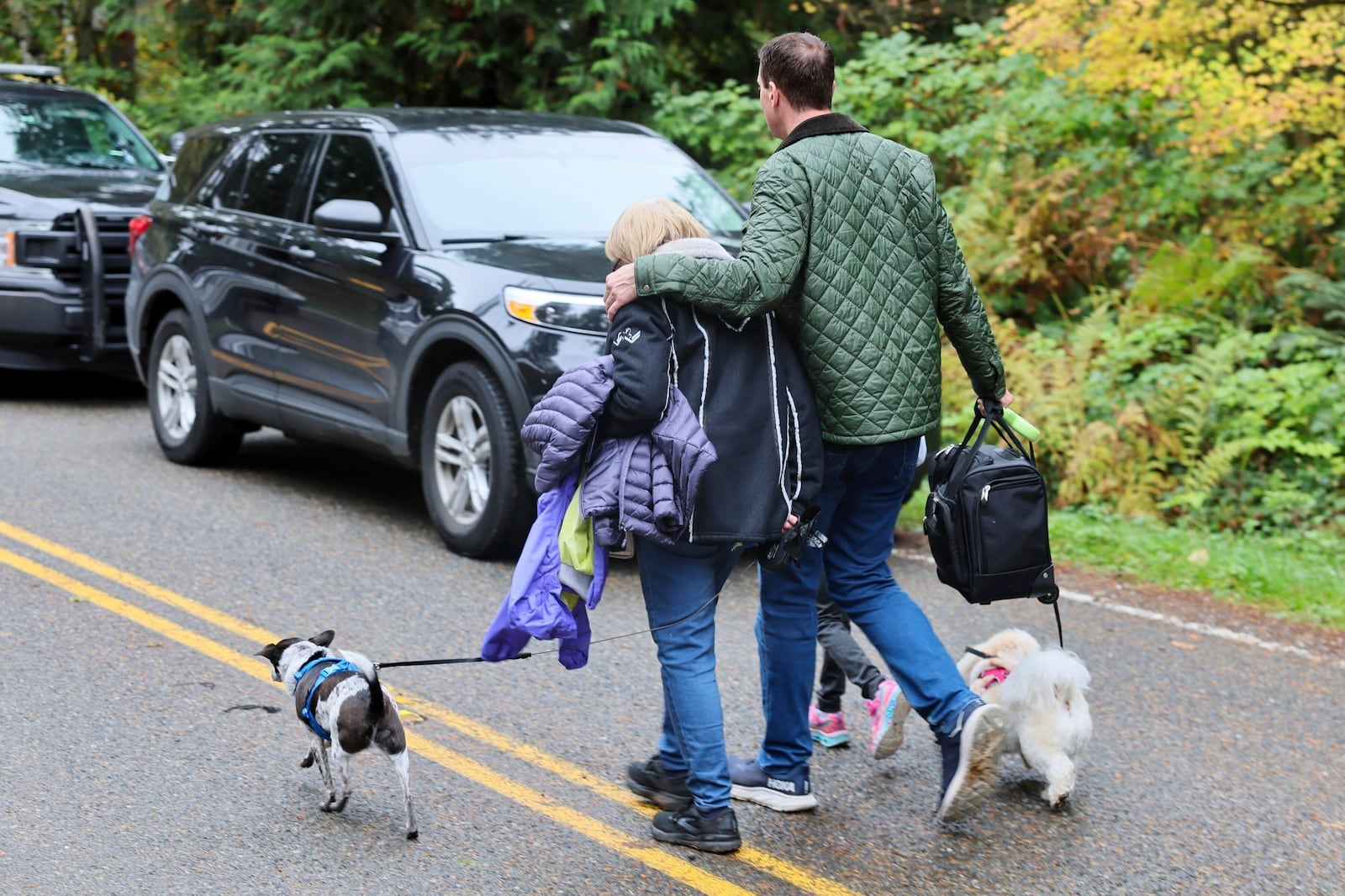 FILE - Neighbors leave the scene of a fatal shooting Monday morning, Oct. 21, 2024, in Fall City, Wash. (Kevin Clark/The Seattle Times via AP, File)