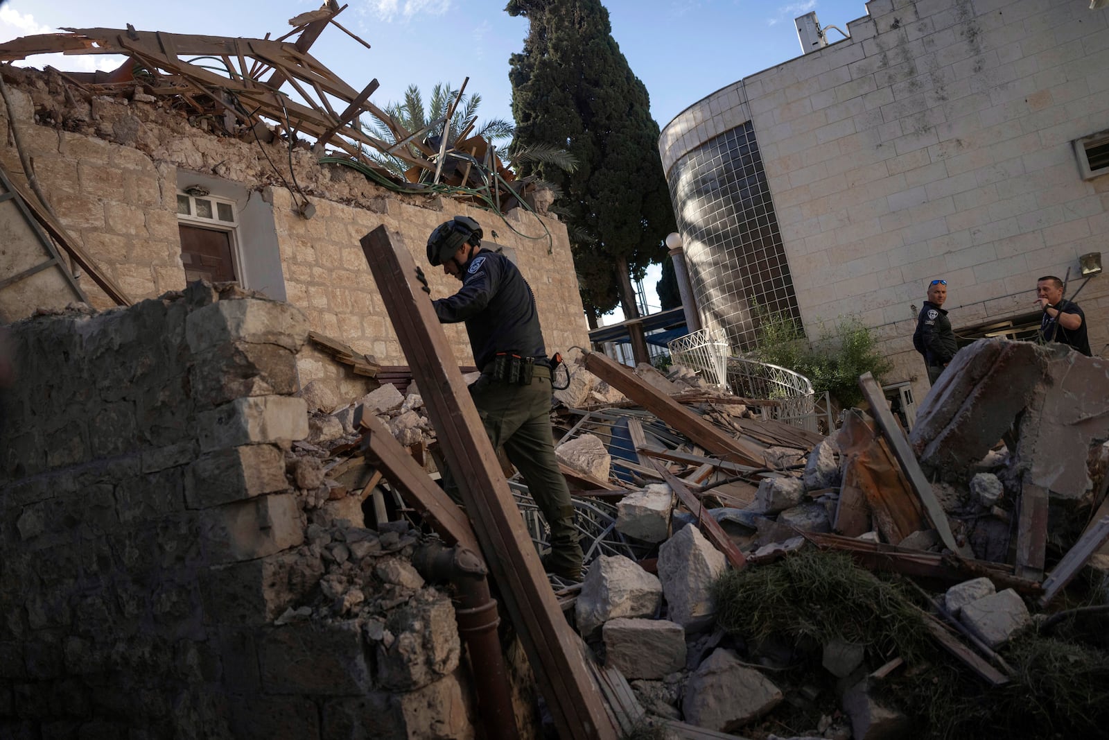 Israeli security forces check a house hit by a rocket fired from Lebanon on Saturday, in Haifa, Israel, Sunday, Nov. 17, 2024. (AP Photo/Ohad Zwigenberg)