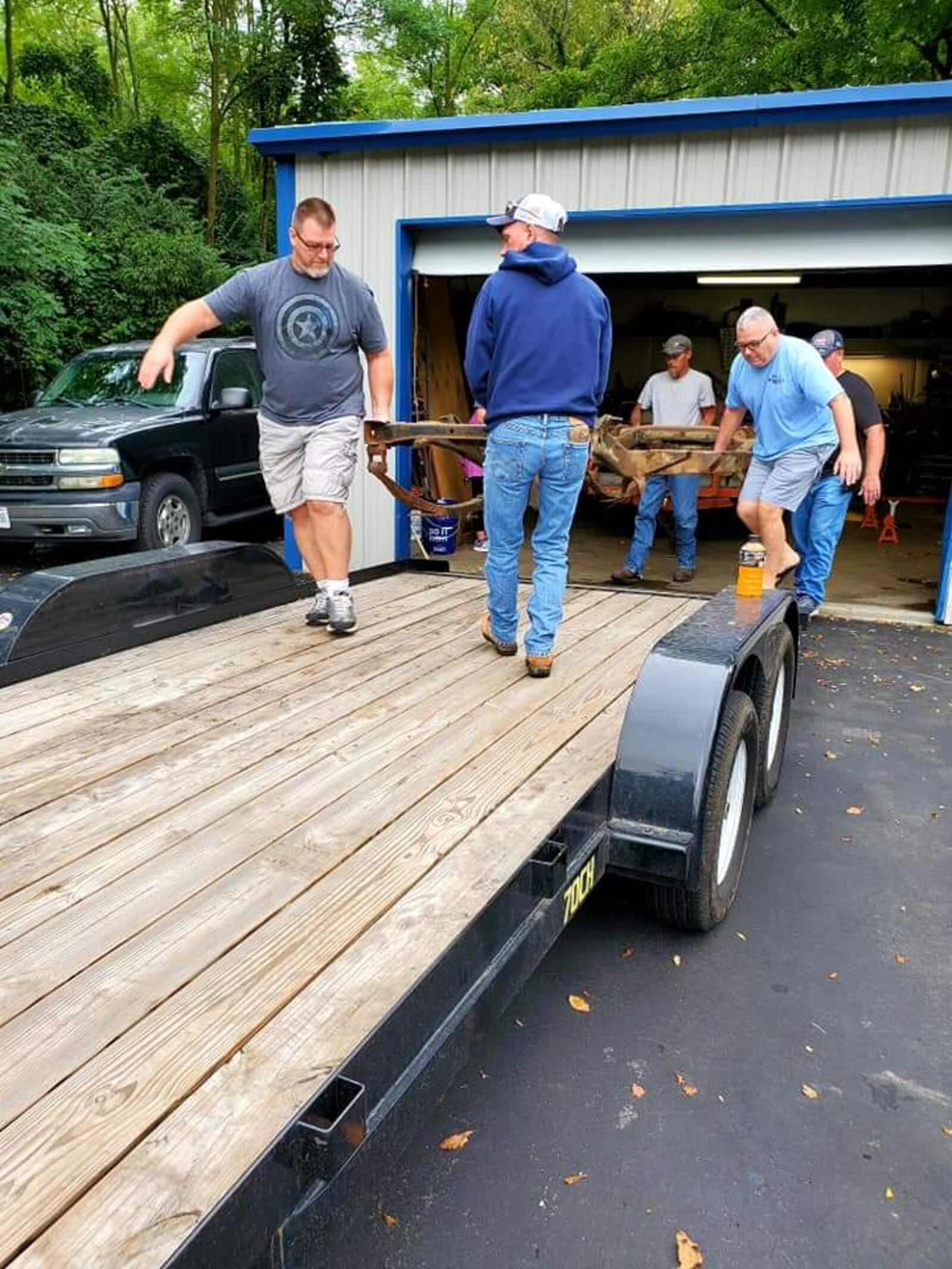 Members of the Middletown Area Jeepers Club load parts of a Jeep belonging to a man with ALS onto a trailer. Several people are planning to rebuild the Jeep and return it to Bill Hammock. SUBMITTED PHOTO