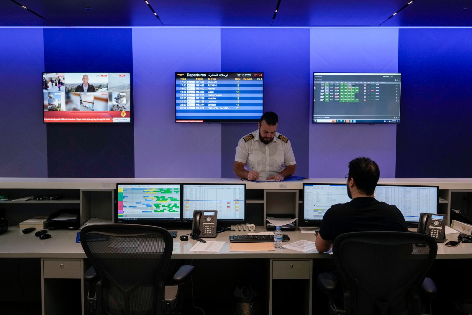 Middle East Airlines employees work in the operations room at the MEA offices in Beirut, Tuesday, Oct. 22, 2024. (AP Photo/Bilal Hussein)