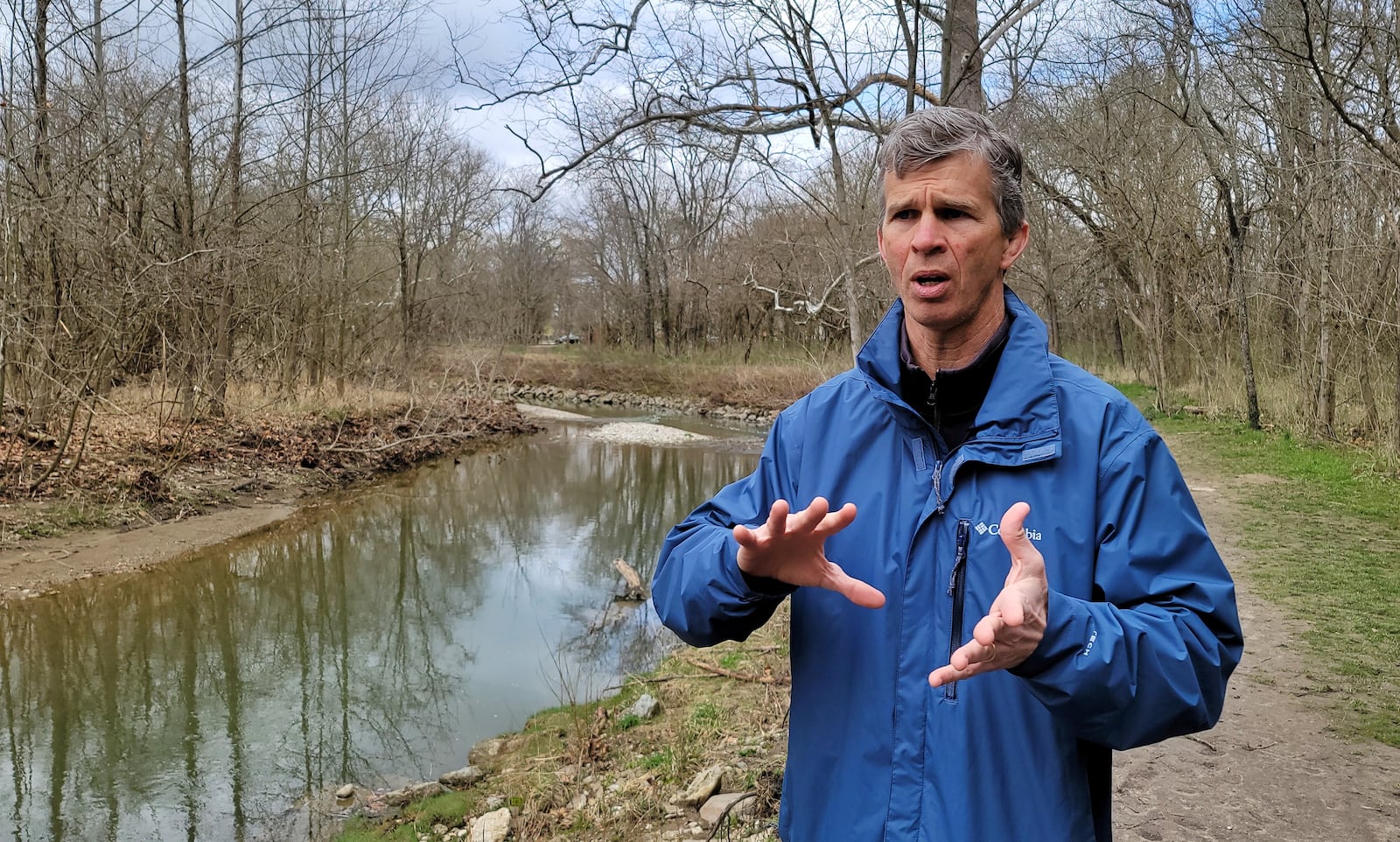 Mike Ekberg, manager of water data and analysis for Miami Conservancy District, talks about how water flows from residential and commercial developments to retention ponds to small streams and creeks to the Great Miami River during a tour discussing water quality in the area. NICK GRAHAM / STAFF