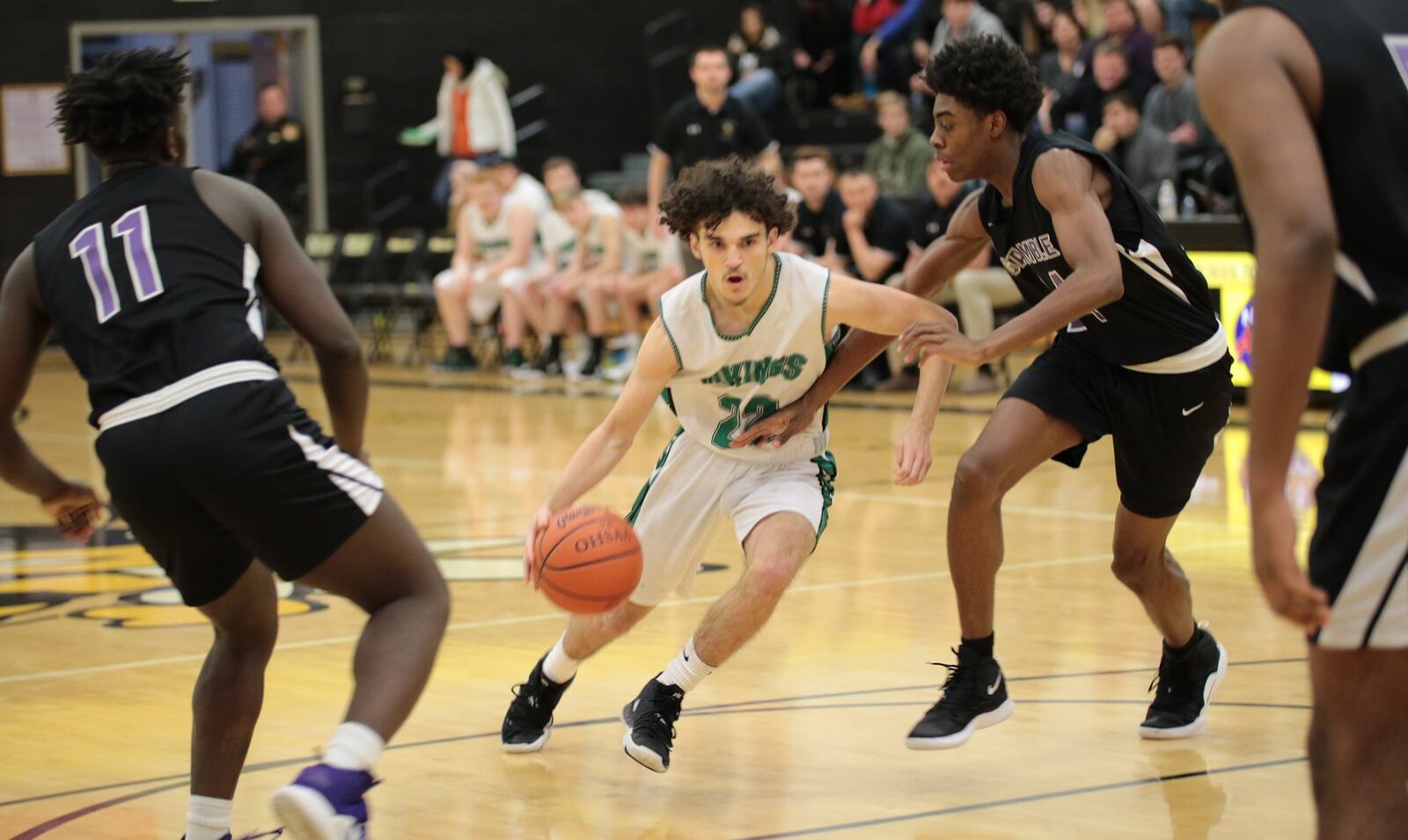 New Miami’s Jordan Robinette drives through the Gamble Montessori defense Saturday night during a Division IV district semifinal basketball game at Taylor. New Miami won 48-47. PHOTO BY KRAE/WWW.KRAEPHOTOGRAPHY.COM