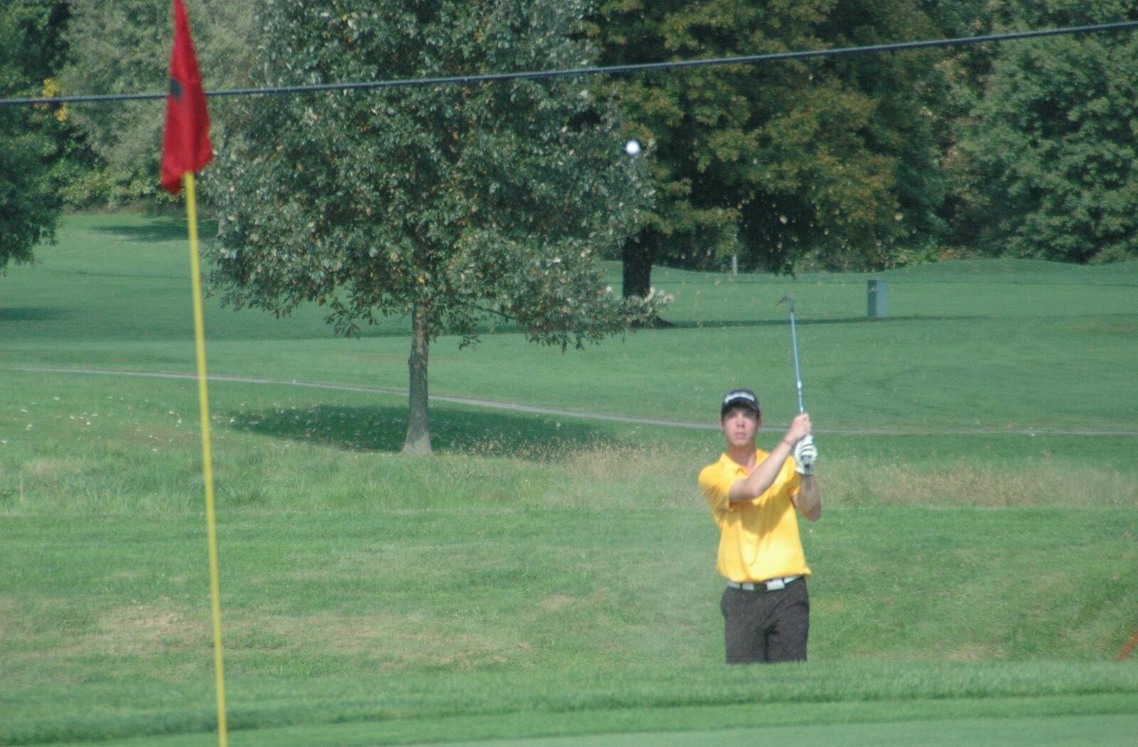 Cole Gronas of Ross delivers a shot out of a sand trap Wednesday during the Division I sectional boys golf tournament at Miami Whitewater Golf Course. RICK CASSANO/STAFF