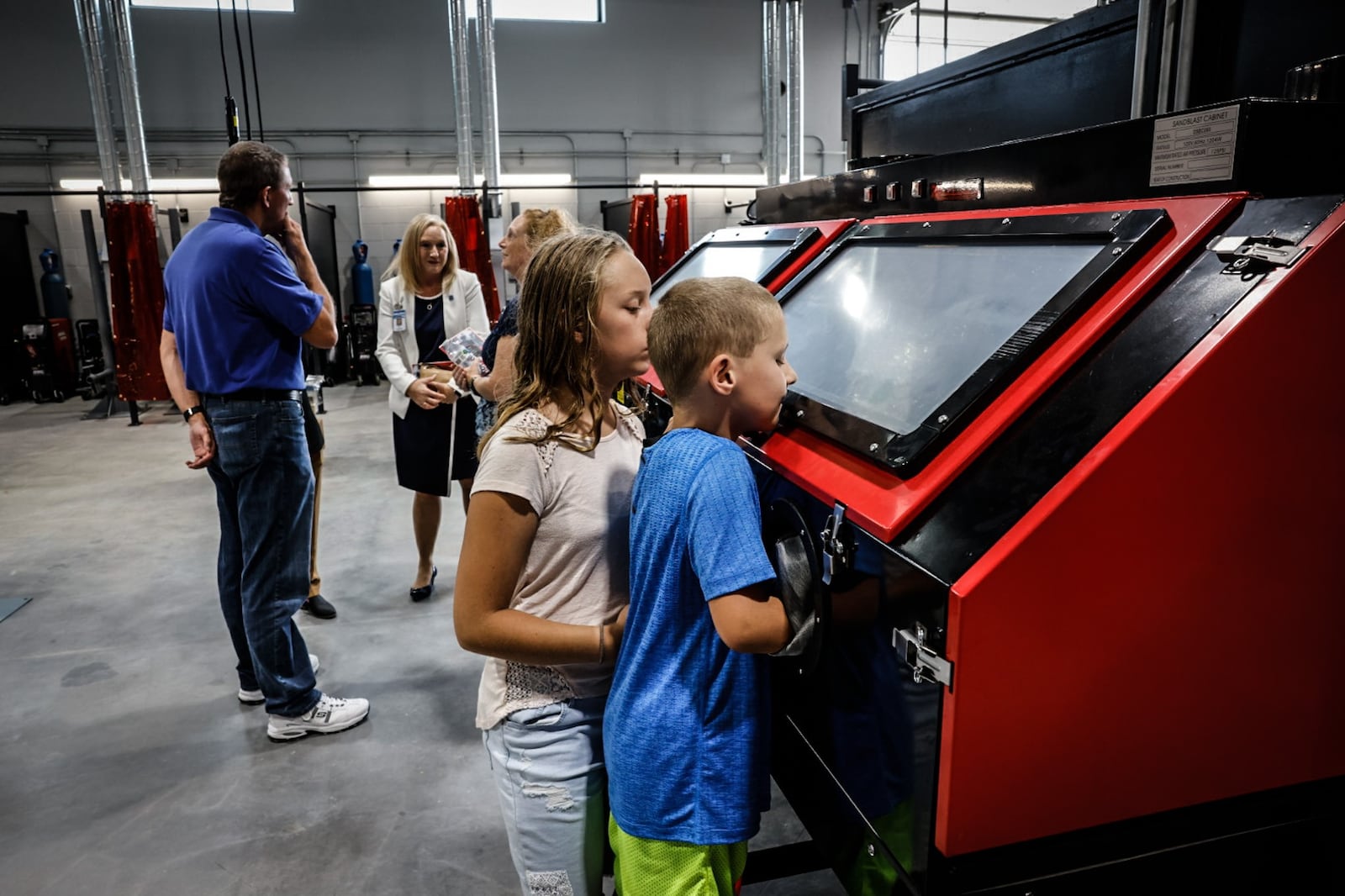 Nate and Sara Dilk check out the Wayne High School Career Tech Center's welding classroom. The new facility will teach three trades; construction, HVAC and construction. JIM NOELKER/STAFF