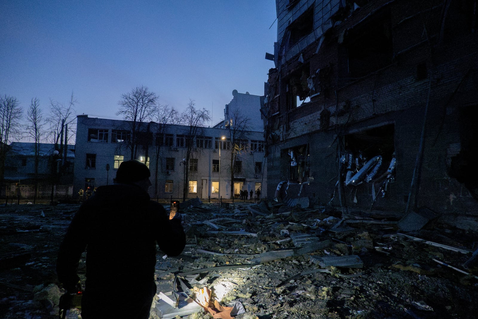 A policeman observes the aftermath of a Russian attack, which injured multiple people in Kyiv, Ukraine, Wednesday, Feb. 12, 2025 (AP Photo/Alex Babenko)