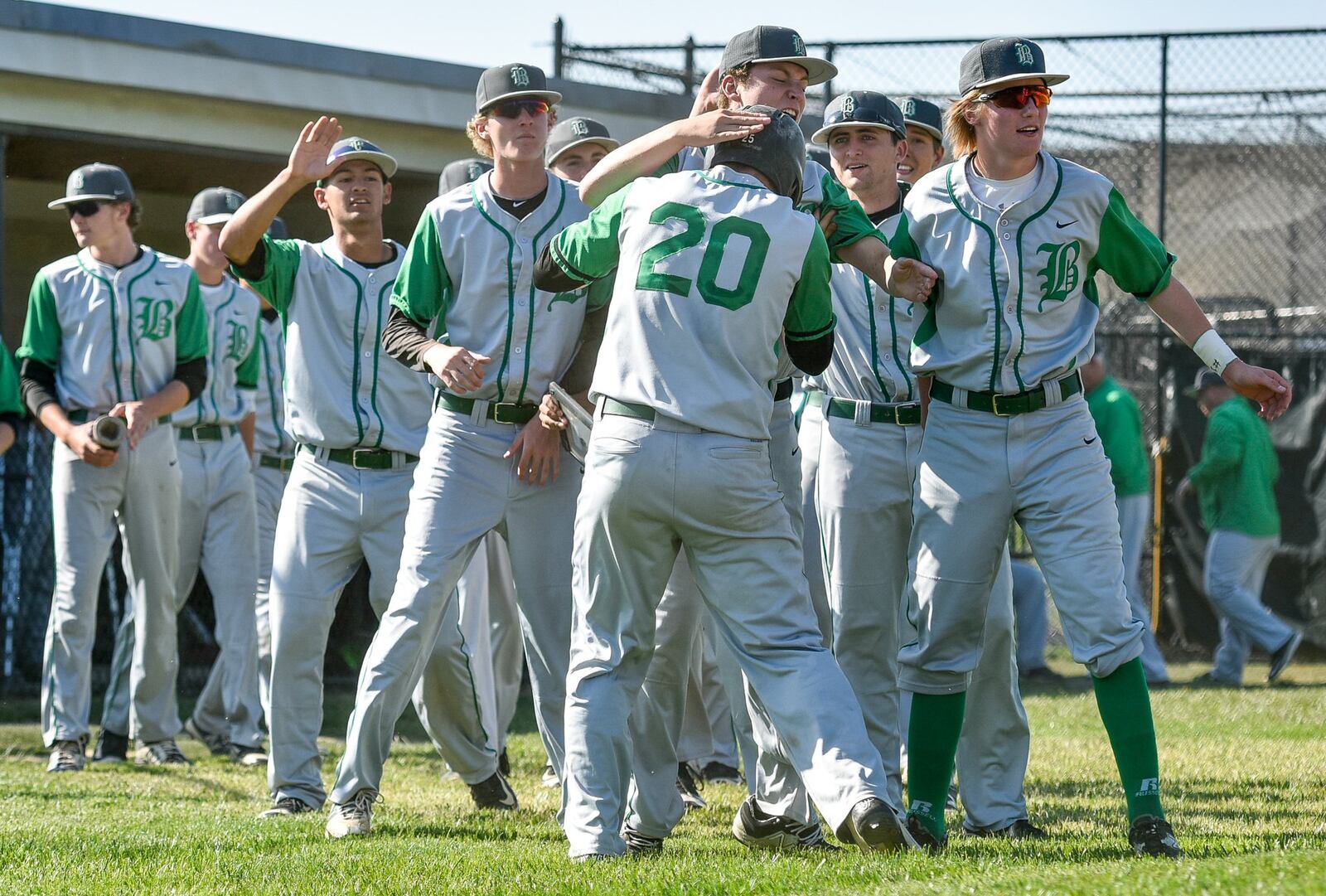 Badin’s Cody Boxrucker (20) celebrates a run with teammates during their Division II sectional final against Fenwick on May 19, 2016, at Edgewood. NICK GRAHAM/STAFF