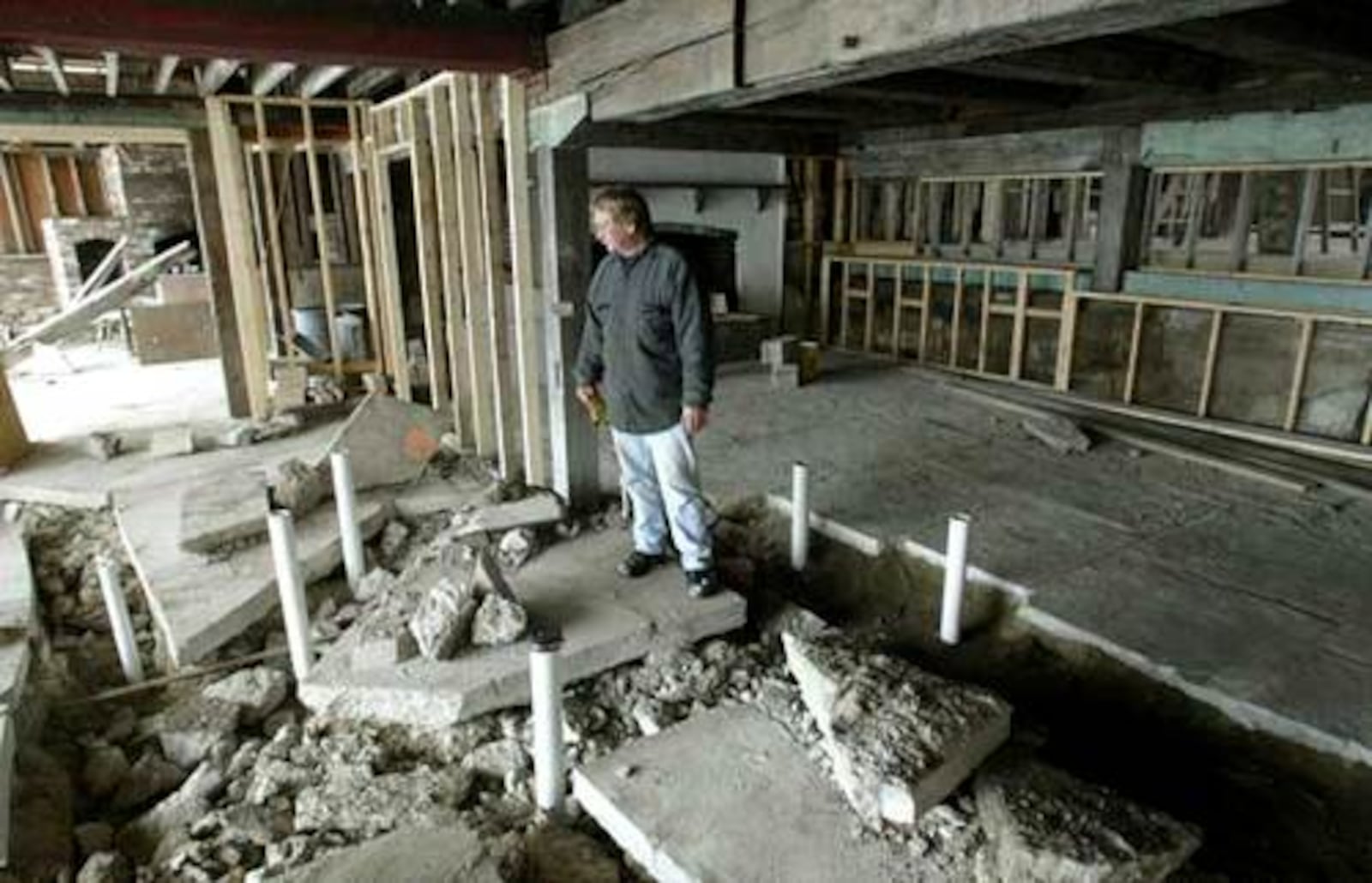 Peerless Mill owner Gary Weigle looks over where a new bar will sit in the Miamisburg restaurant being rebuilt after a fire.