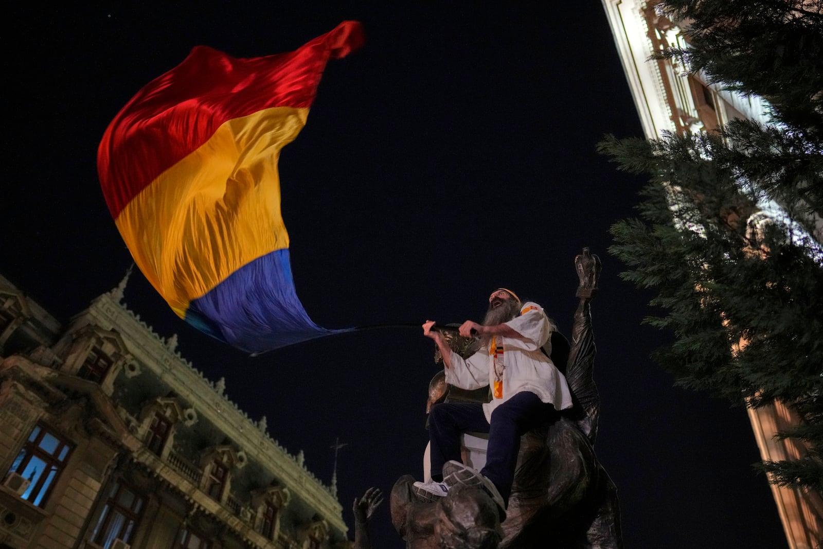 A supporter of Calin Georgescu reacts during a protest after Romania's electoral body rejected his candidacy in the presidential election rerun in Bucharest, Romania, Sunday, March 9, 2025. (AP Photo/Vadim Ghirda)