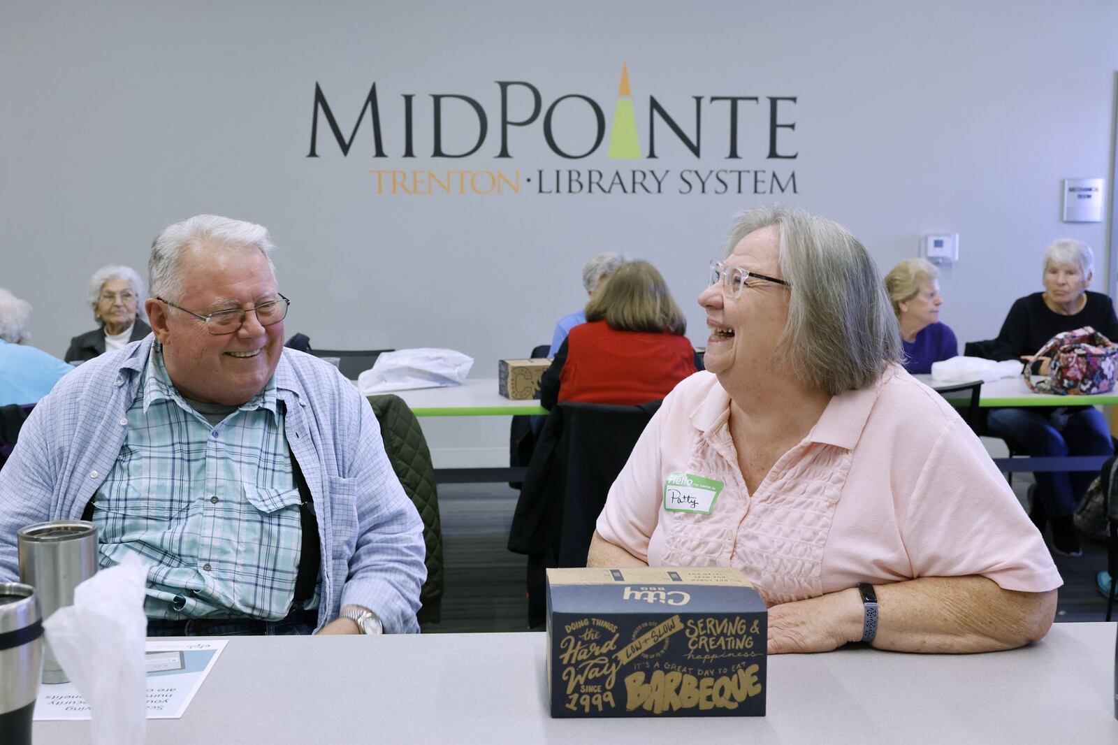 Paul Hilton, left, and Patty Sullivan laugh as they gather for lunch at the MidPointe Library in Trenton Wednesday, Nov. 22, 2023. NICK GRAHAM/STAFF