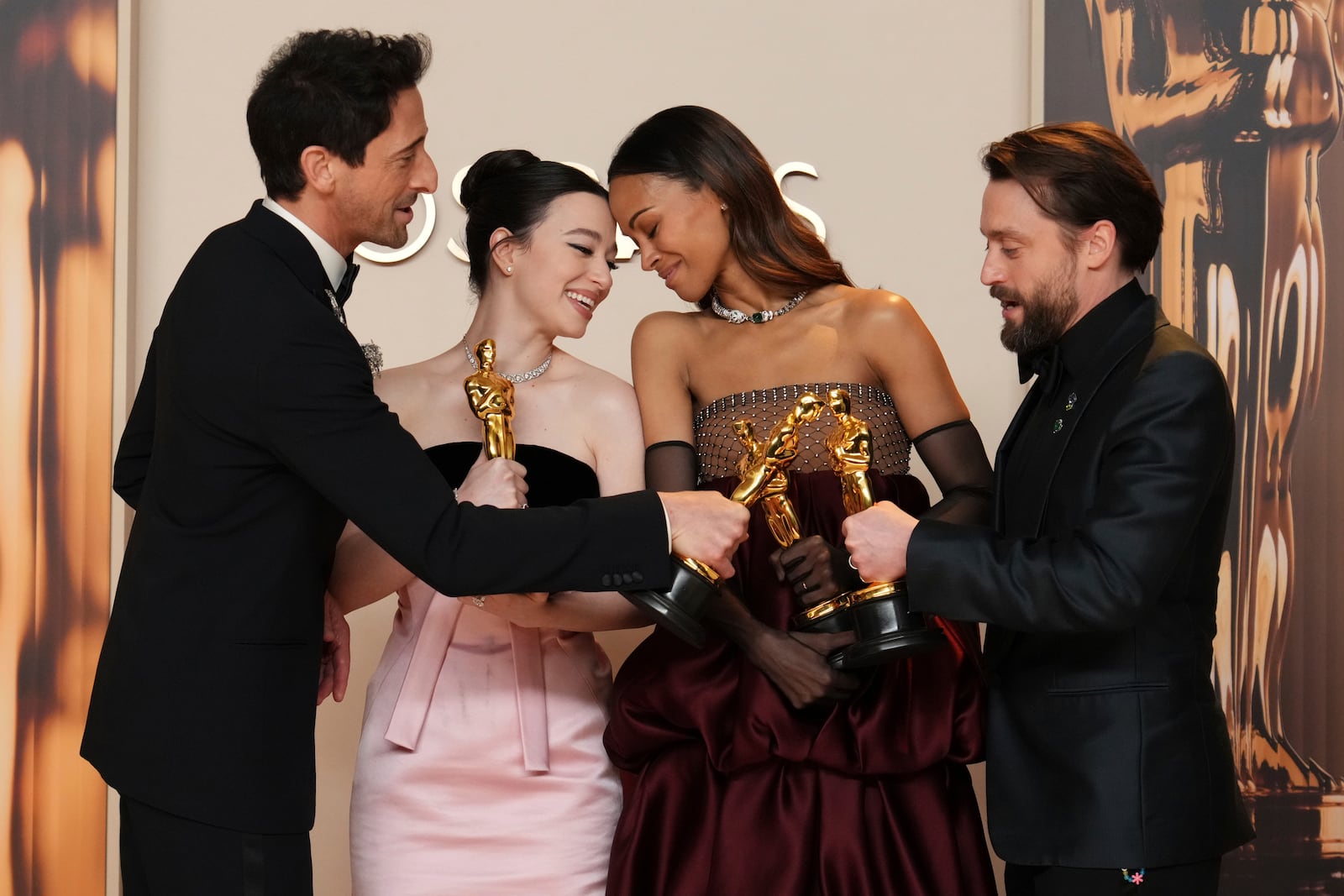 Adrien Brody, from left, winner of the award for best performance by an actor in a leading role for "The Brutalist," Mikey Madison, winner of the award for best performance by an actress in a leading role for "Anora," Zoe Saldana, winner of the award for best performance by an actress in a supporting role for "Emilia Perez," and Kieran Culkin, winner of the award for best performance by an actor in a supporting role for "A Real Pain," pose in the press room at the Oscars on Sunday, March 2, 2025, at the Dolby Theatre in Los Angeles. (Photo by Jordan Strauss/Invision/AP)