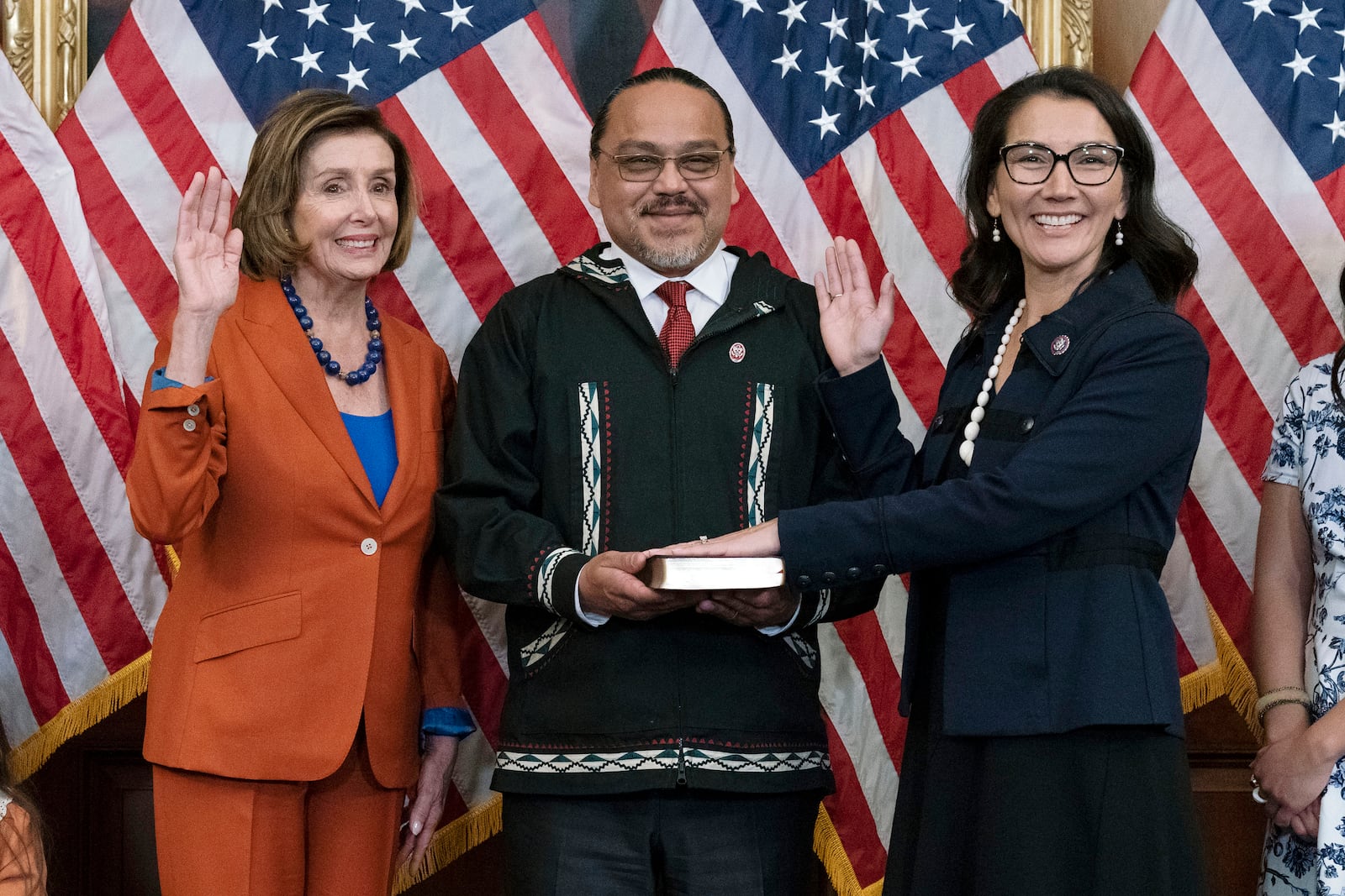 FILE - Speaker of the House Nancy Pelosi of Calif., left, administers the House oath of office to Rep. Mary Peltola, D-Alaska, accompanied by her husband Eugene "Buzzy" Peltola Jr., center, during a ceremonial swearing-in on Capitol Hill in Washington, Tuesday, Sept. 13, 2022. (AP Photo/Jose Luis Magana, File)