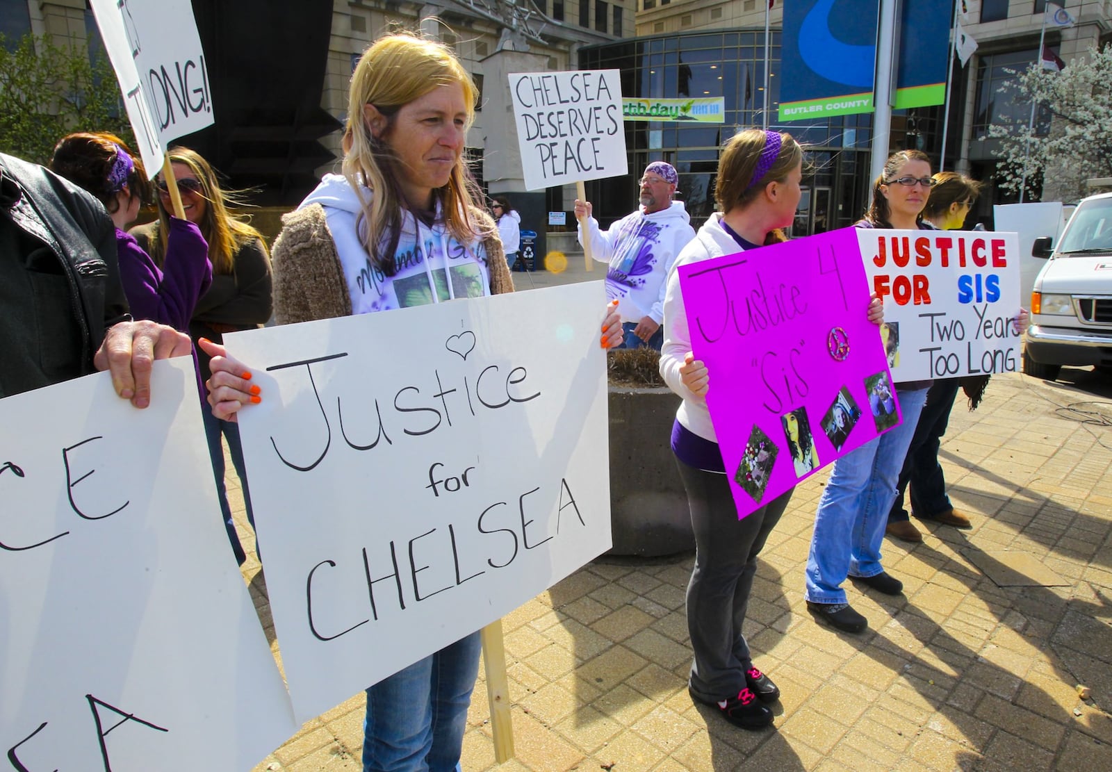 On the two-year anniversary of Chelsea Johnson’s homicide in Fairfield, family and friends, including Chelsea’s mother Vicky Fible, center, held a vigil outside the Butler County Government Services Center in Hamilton, Wednesday, April 16, 2014. GREG LYNCH / STAFF