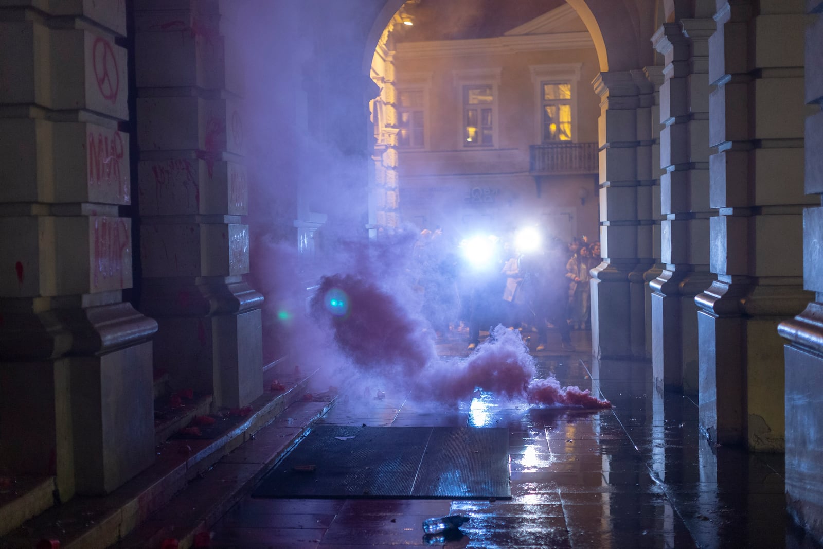 A flare burns in front of the City Hall building during a protest in rage over last week's collapse of a concrete canopy at the railway station that killed 14 people, in Novi Sad, Serbia, Tuesday, Nov. 5, 2024. (AP Photo/Marko Drobnjakovic)