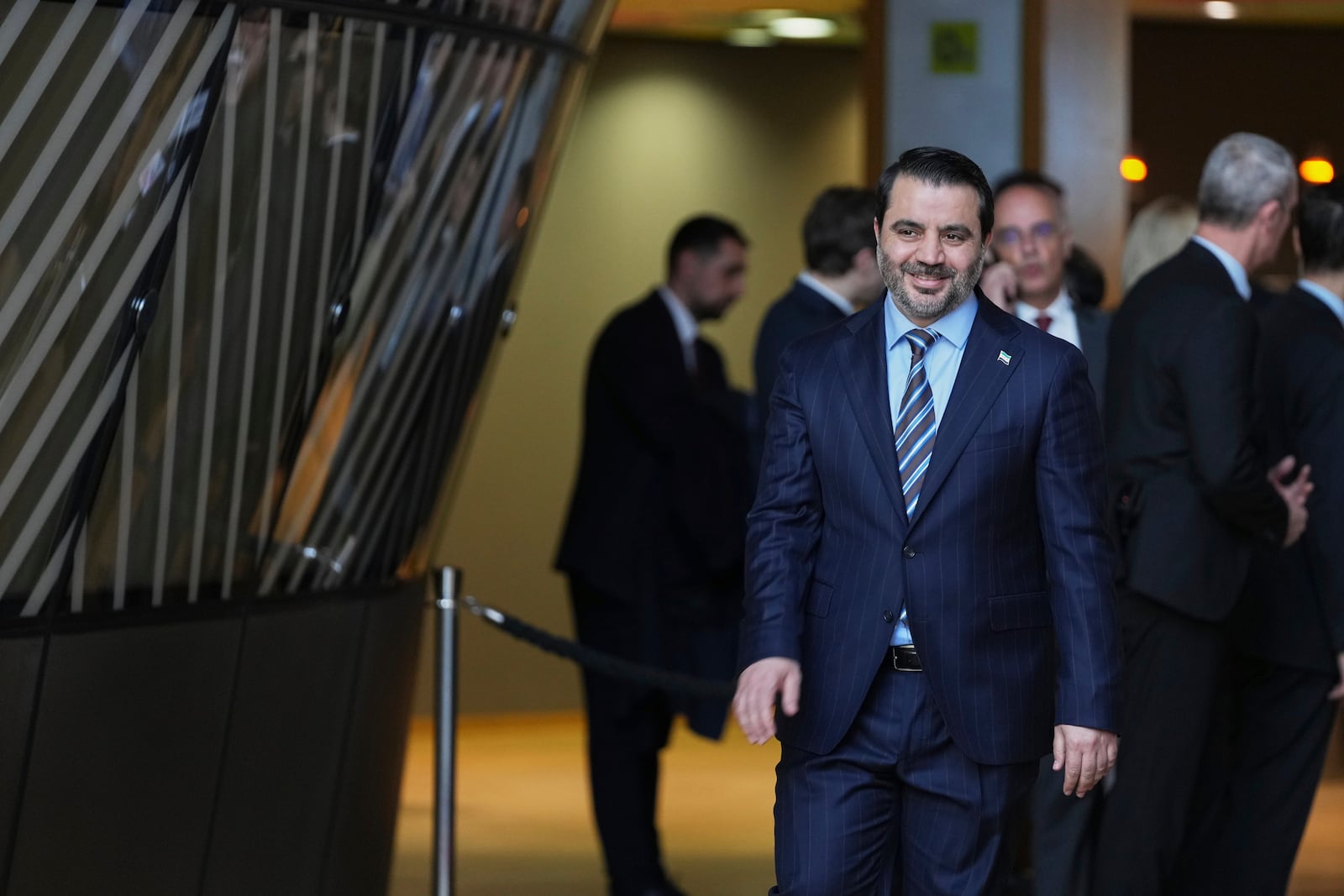 Syrian Foreign Minister Asaad Hassan al-Shibani arrives for a group photo at the 9th international conference in support of Syria at the European Council building in Brussels, Monday, March 17, 2025. (AP Photo/Virginia Mayo)