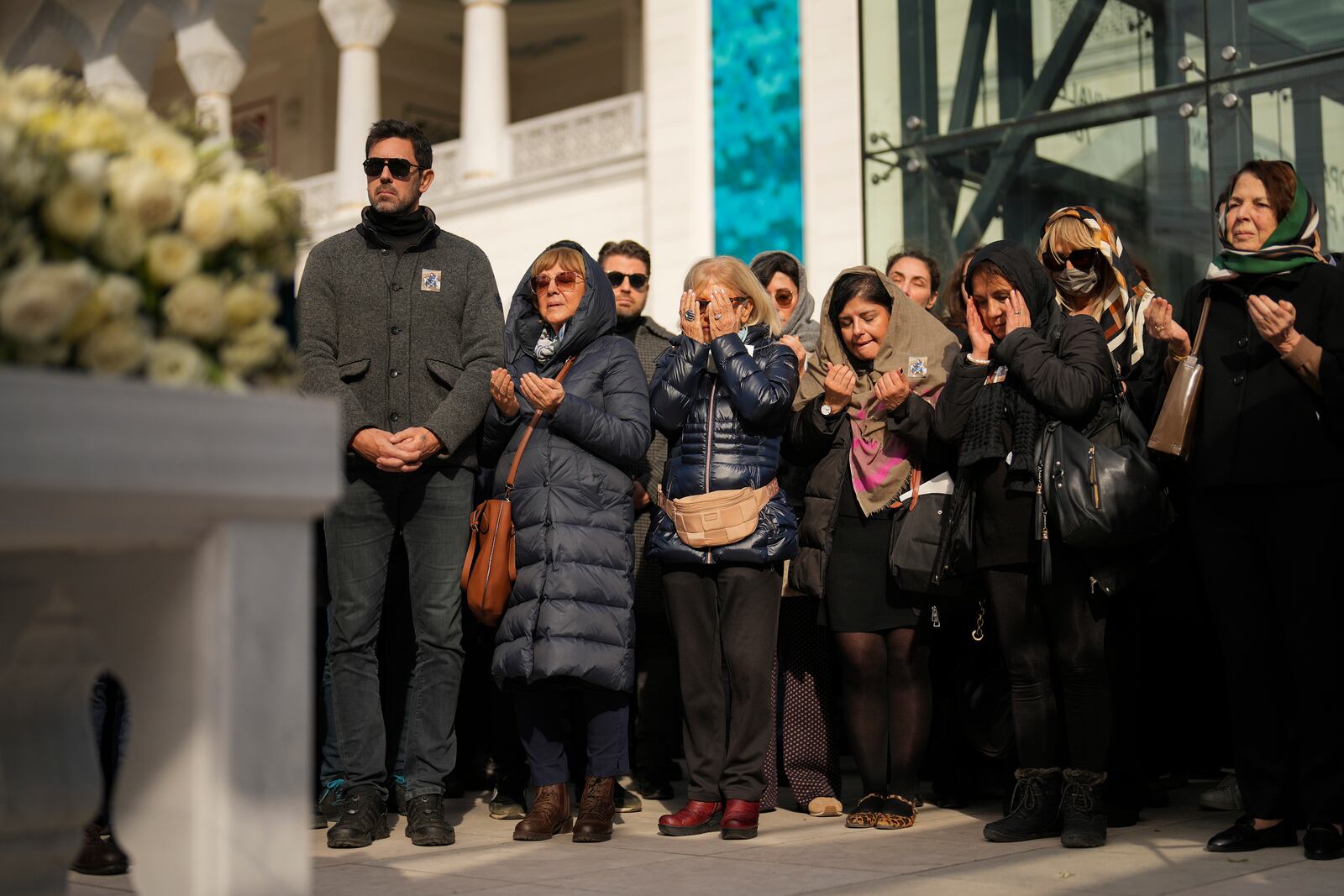 Relatives mourn during the funeral of three members of the Inal family, who died in a fire that broke out at the Kartalkaya ski resort, at the Barbaros Hayreddin Pasa mosque in Istanbul, Turkey, Friday, Jan. 24, 2025. (AP Photo/Francisco Seco)