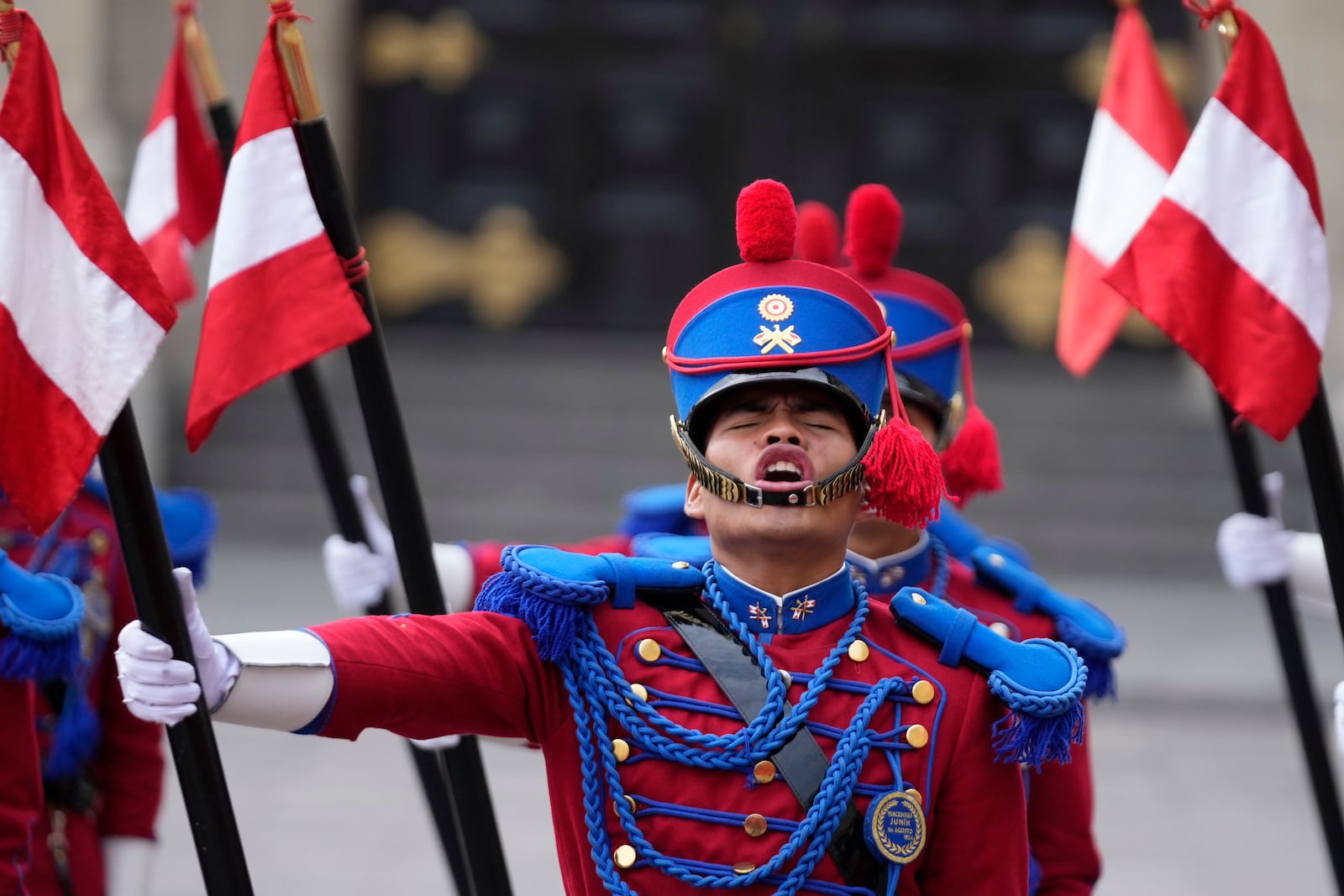 A Peruvian honor guard sing their national anthem during a welcoming ceremony for South Korea's President Yoon Suk Yeol at the government palace in Lima, Peru, Saturday, Nov. 16, 2024, following the closing of the Asia-Pacific Economic Cooperation (APEC) summit. (AP Photo/Fernando Vergara)