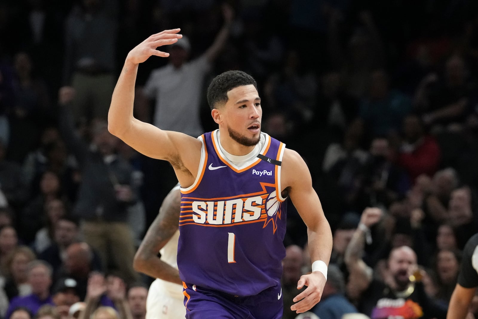 Phoenix Suns guard Devin Booker celebrates his 3-pointer against the Minnesota Timberwolves during the first half of an NBA basketball game Wednesday, Jan. 29, 2025, in Phoenix. (AP Photo/Ross D. Franklin)